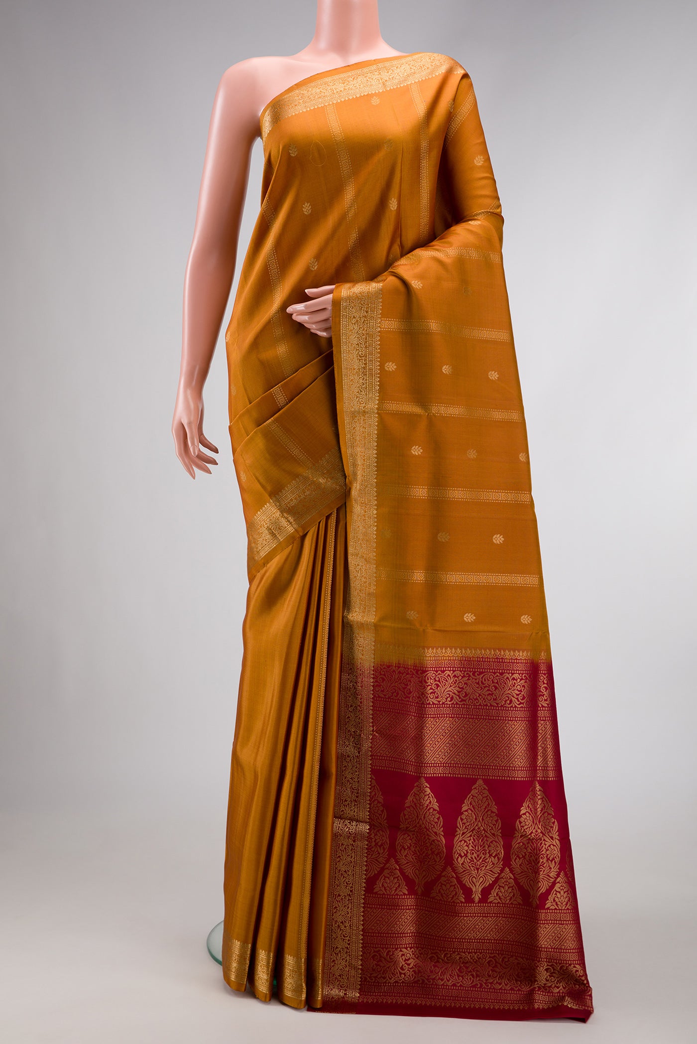 Mustard Dual Tone Soft Silk Saree with Zari Butta on the body and Zari Border.  displayed on a mannequin