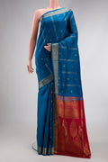 Peacock Blue Dual Tone Soft Silk Saree with Zari Butta on the body and Zari Border.  displayed on a mannequin
