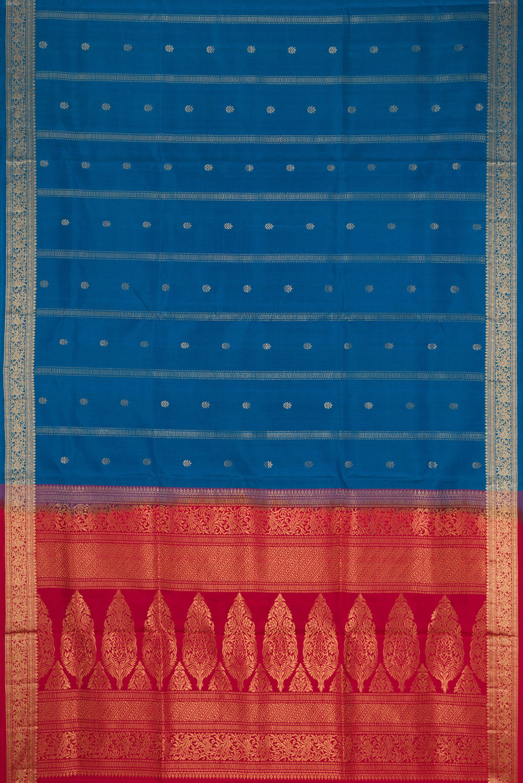 Flat view of Peacock Blue Dual Tone Soft Silk Saree with Zari Butta on the body and Zari Border. 