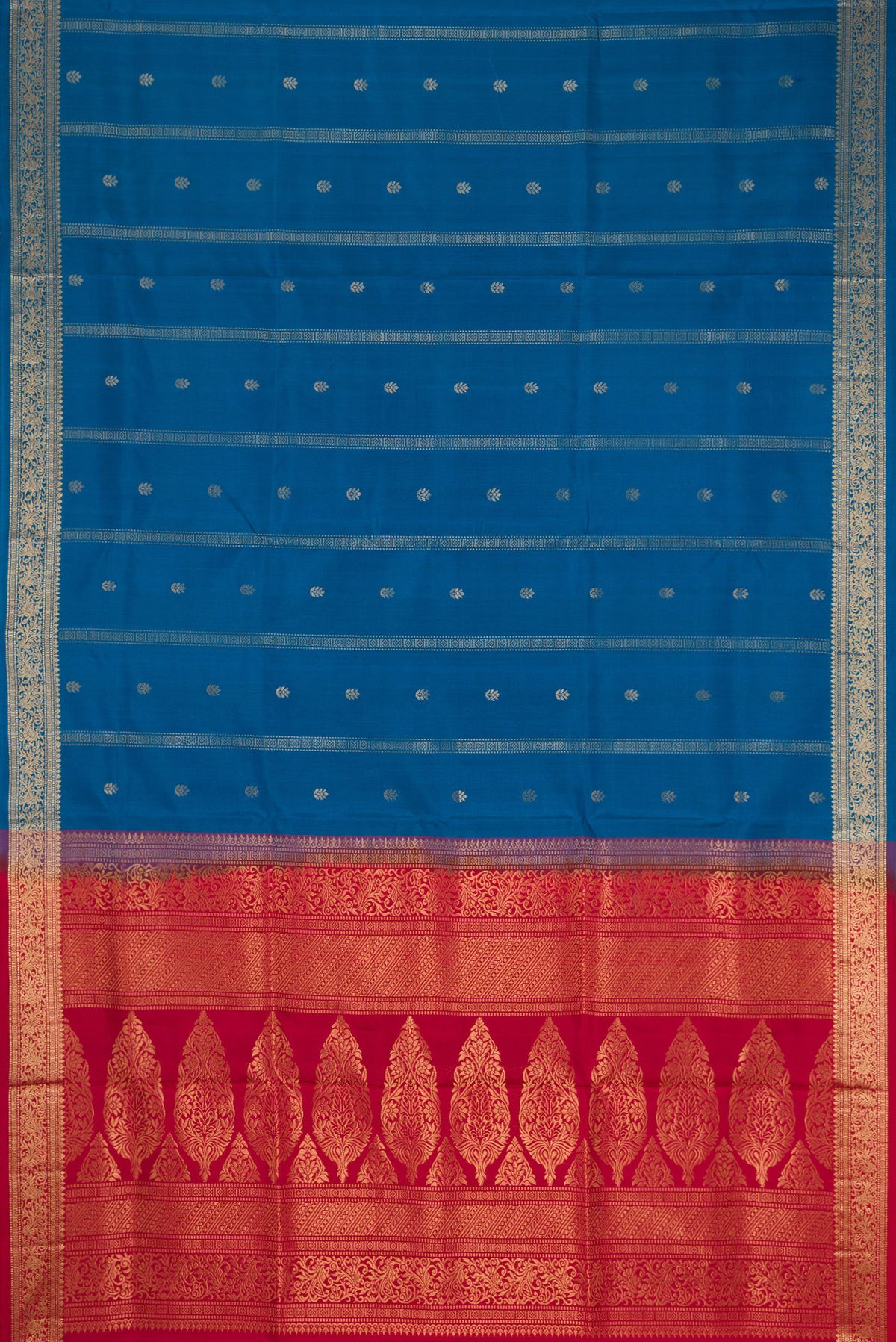 Flat view of Peacock Blue Dual Tone Soft Silk Saree with Zari Butta on the body and Zari Border. 
