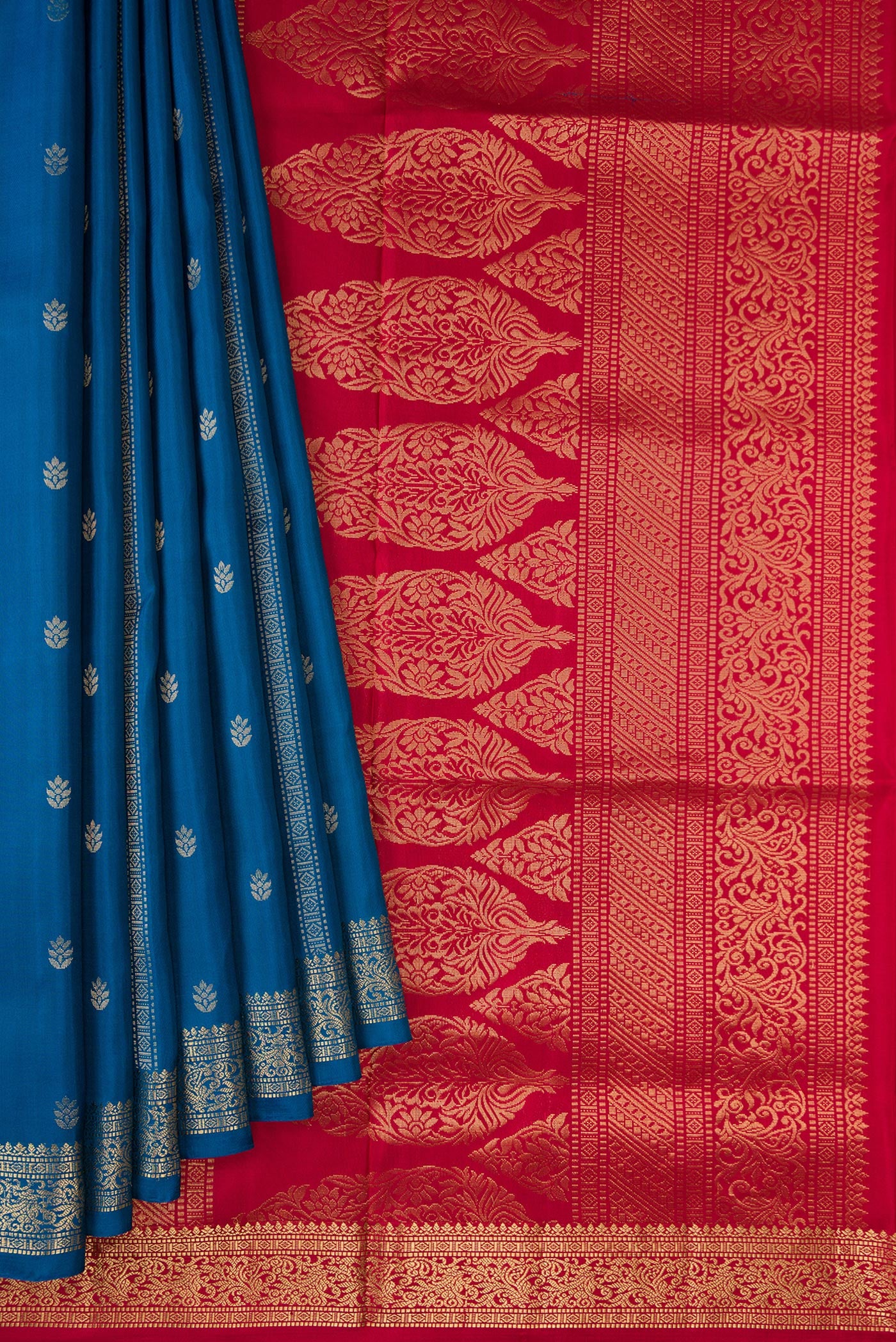 Pleats and pallu of Peacock Blue Dual Tone Soft Silk Saree with Zari Butta on the body and Zari Border. 