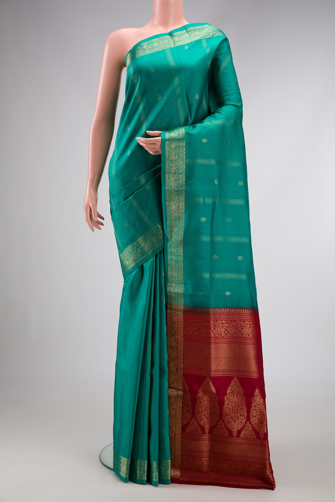 Green Dual Tone Soft Silk Saree with Zari Butta on the body and Zari Border.  displayed on a mannequin