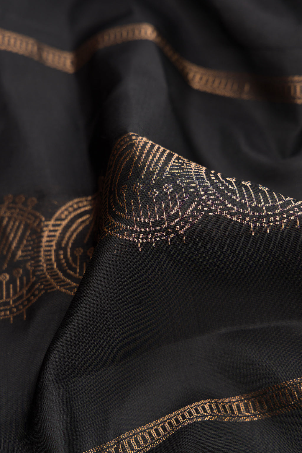 Close up of Black Dual Tone Soft Silk Saree with Stripes on the body and Without Border.  displaying folds
