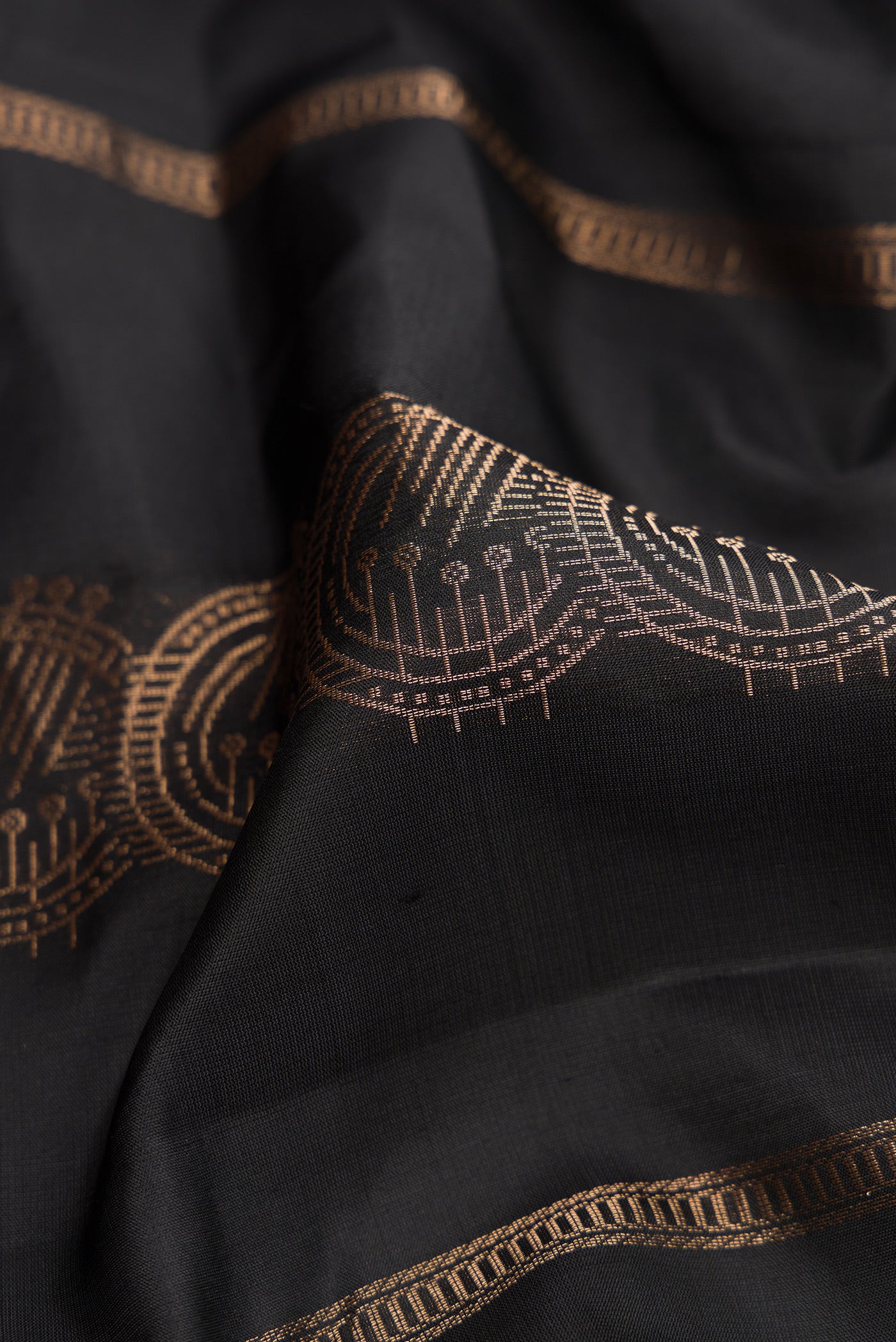 Close up of Black Dual Tone Soft Silk Saree with Stripes on the body and Without Border.  displaying folds