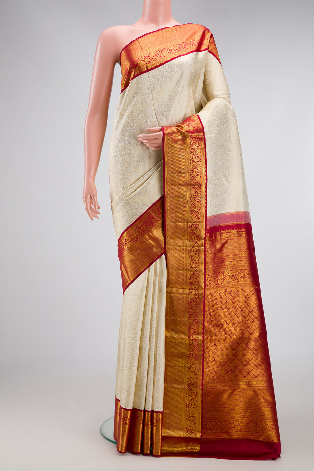 Off White Kanjivaram Silk Saree with Zari Brocade on the body and Zari Border.  displayed on a mannequin