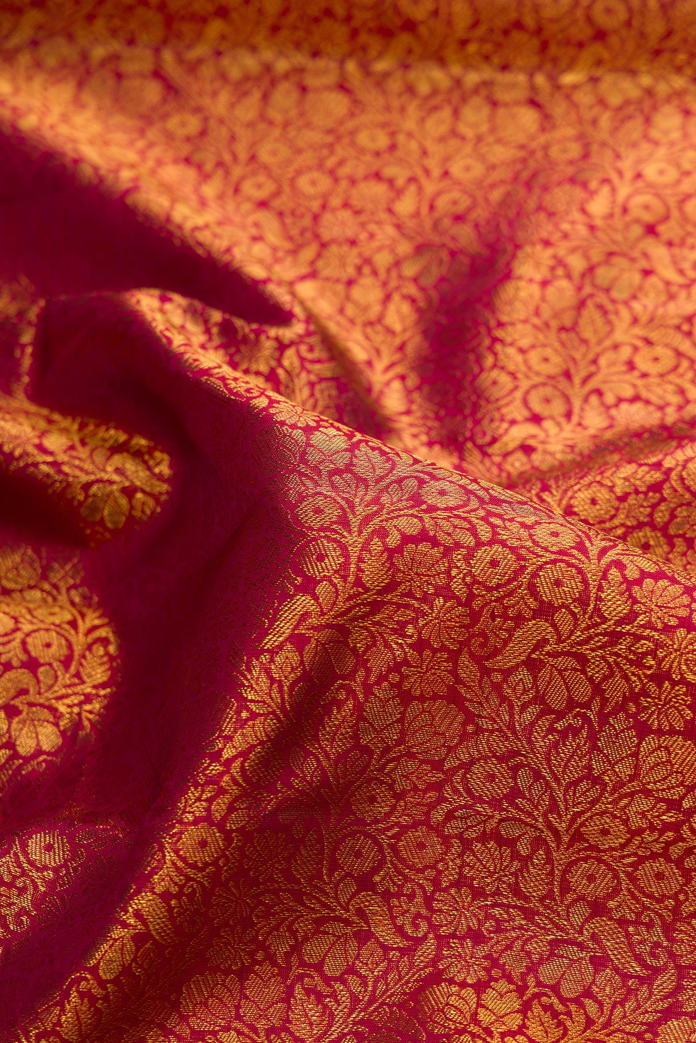 Close up of Maroon Dual Tone Kanchipuram Silk Saree with Zari Brocade on the body and Zari Border.  displaying folds