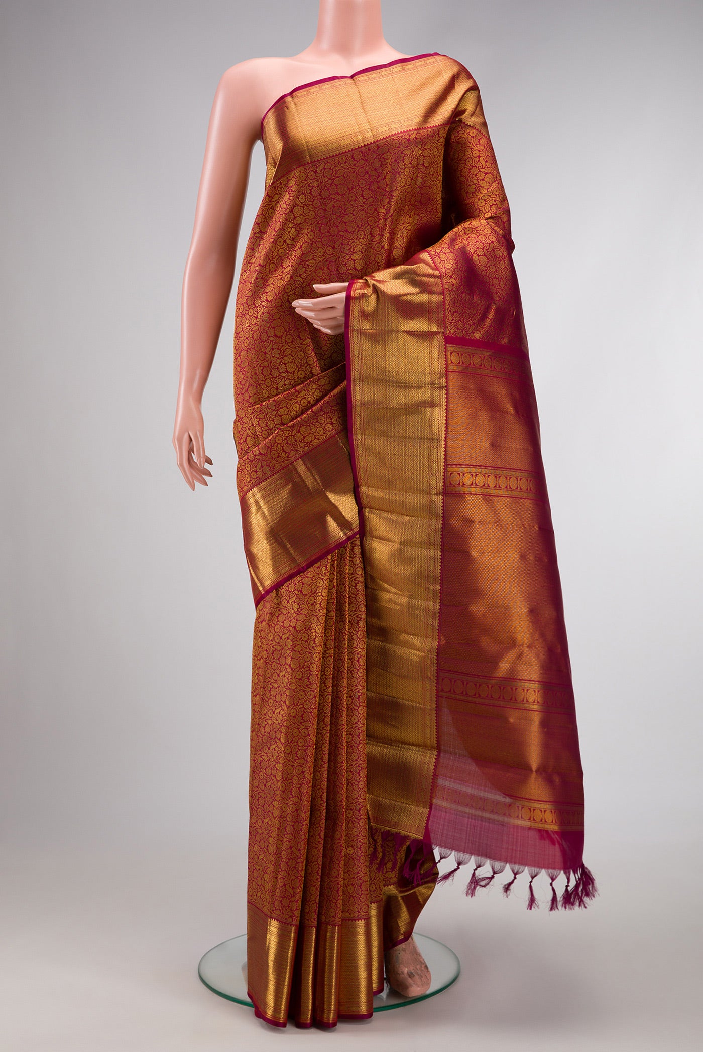 Maroon Dual Tone Kanchipuram Silk Saree with Zari Brocade on the body and Zari Border.  displayed on a mannequin