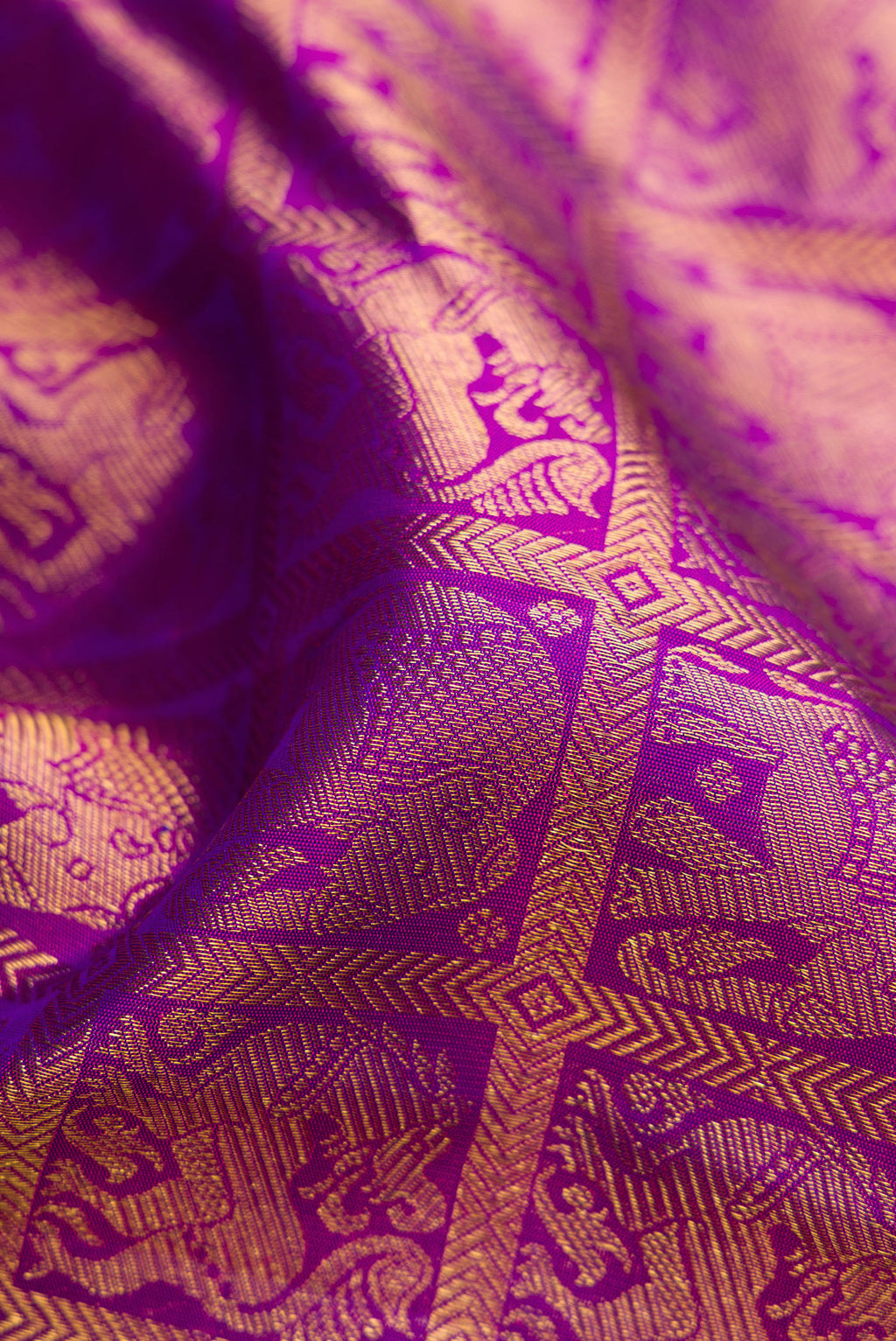 Close up of Violet Dual Tone Kanchipuram Silk Saree with Zari Brocade on the body and Zari Border.  displaying folds