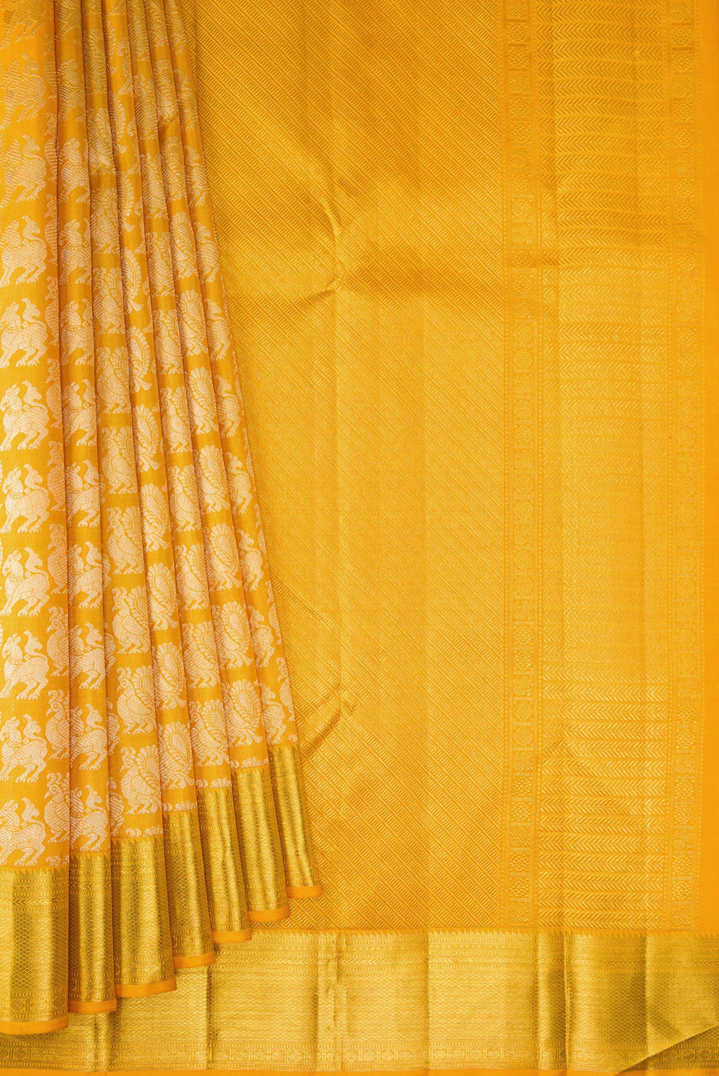 Pleats and pallu of Mustard Kanchipuram Silk Saree with Zari Brocade on the body and Zari Border. 
