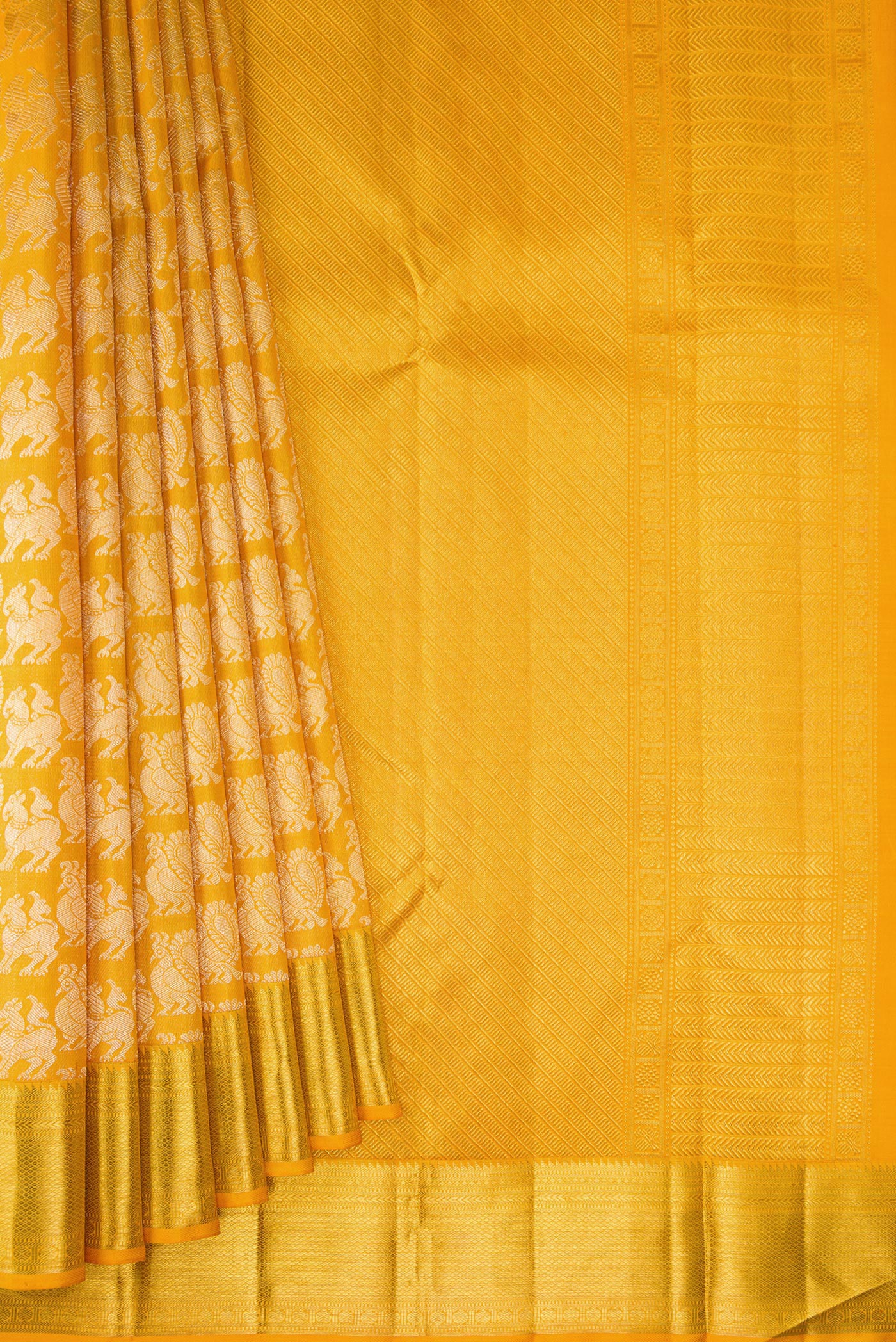 Pleats and pallu of Mustard Kanchipuram Silk Saree with Zari Brocade on the body and Zari Border. 