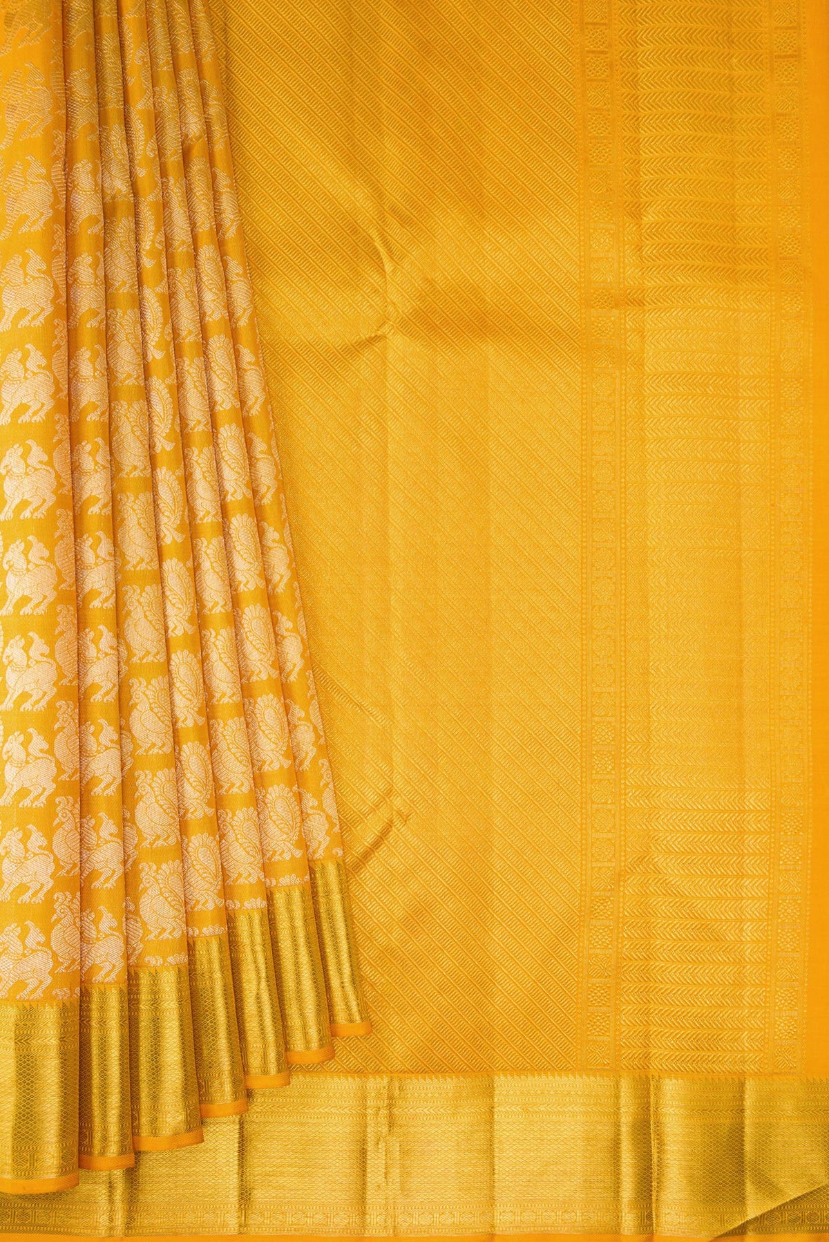 Pleats and pallu of Mustard Kanchipuram Silk Saree with Zari Brocade on the body and Zari Border. 