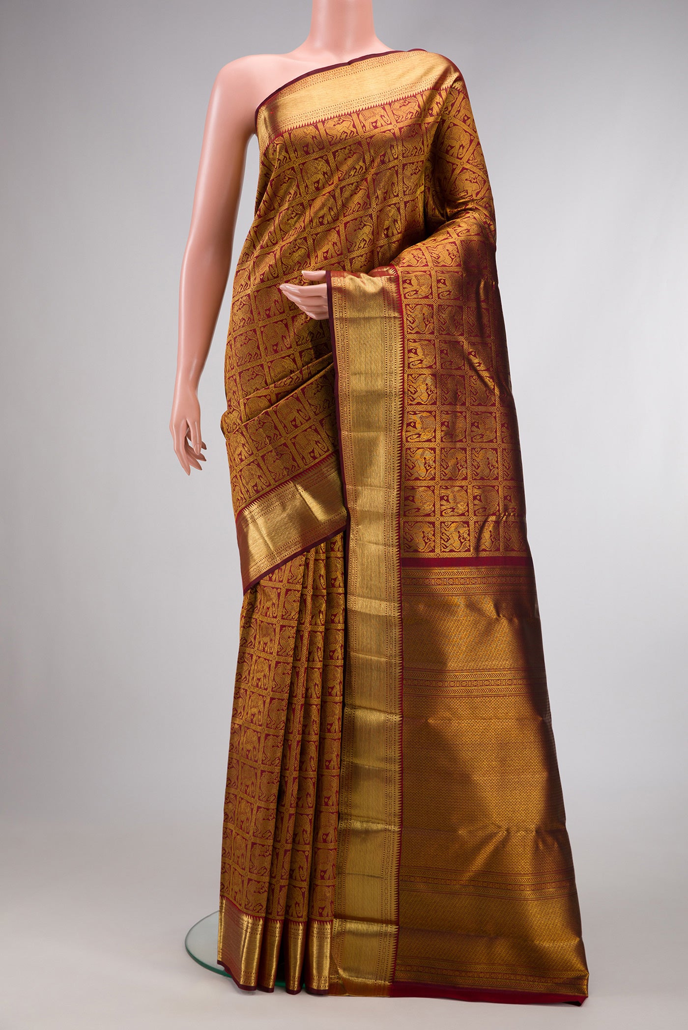 Maroon Dual Tone Kanchipuram Silk Saree with Zari Brocade on the body and Zari Border.  displayed on a mannequin
