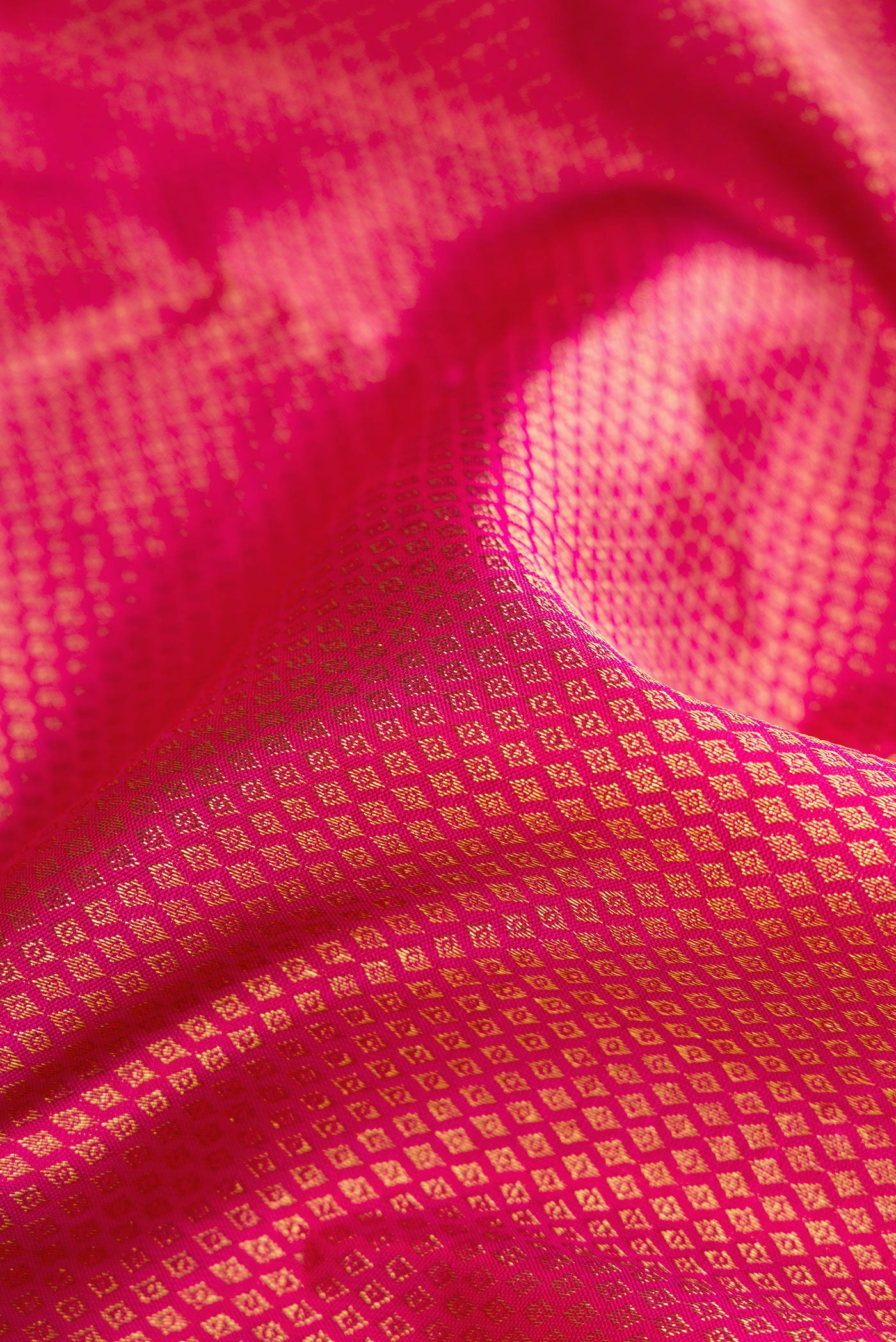 Close up of Pink Dual Tone Kanchipuram Silk Saree with Zari Brocade on the body and Zari Border.  displaying folds