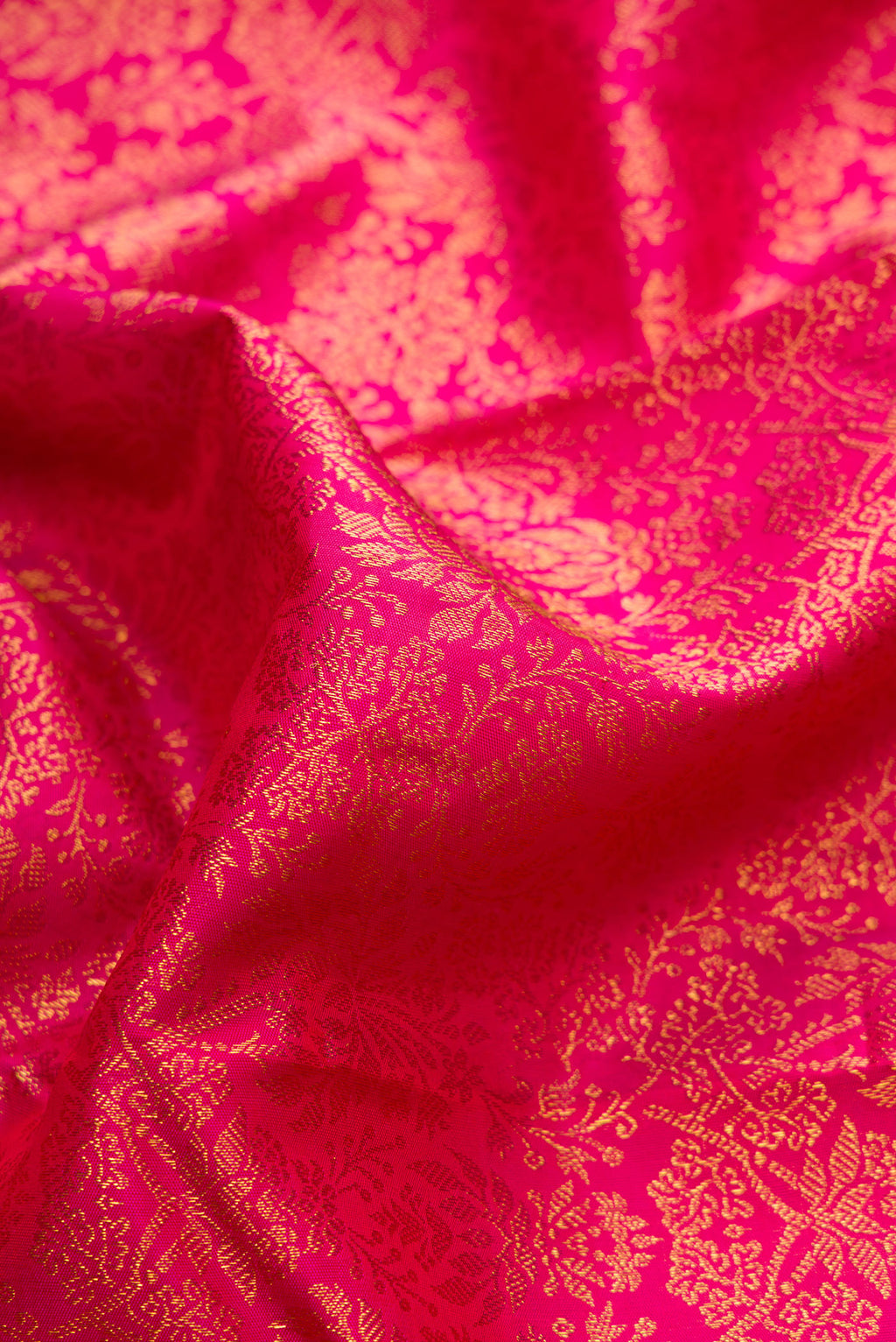 Close up of Dark Pink Dual Tone Kanchipuram Silk Saree with Zari Brocade on the body and Zari Border.  displaying folds