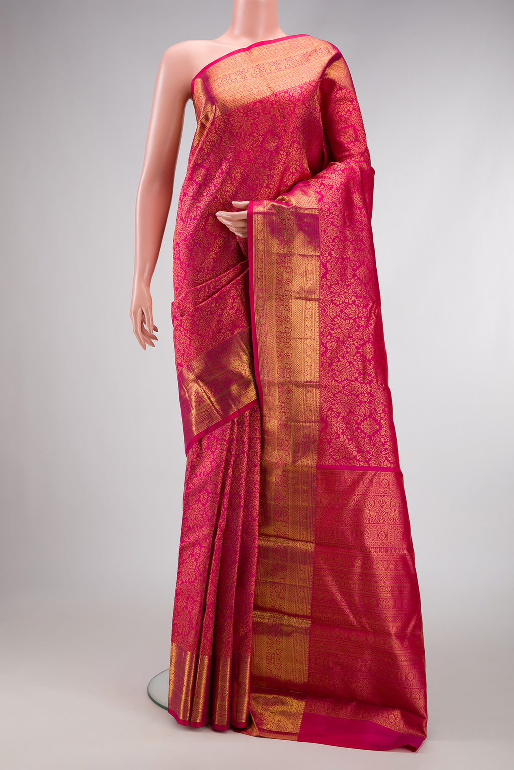 Dark Pink Dual Tone Kanchipuram Silk Saree with Zari Brocade on the body and Zari Border.  displayed on a mannequin