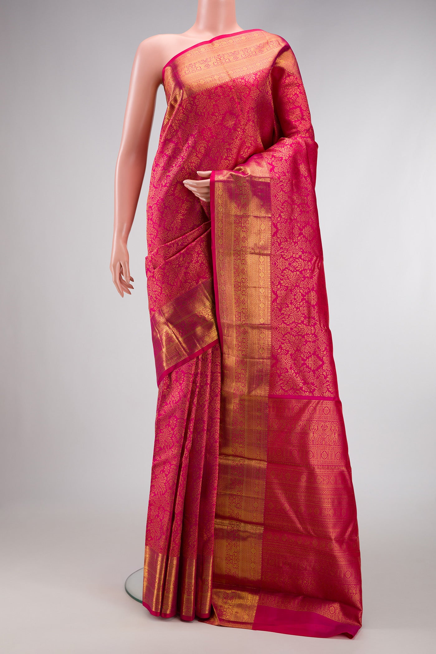 Dark Pink Dual Tone Kanchipuram Silk Saree with Zari Brocade on the body and Zari Border.  displayed on a mannequin