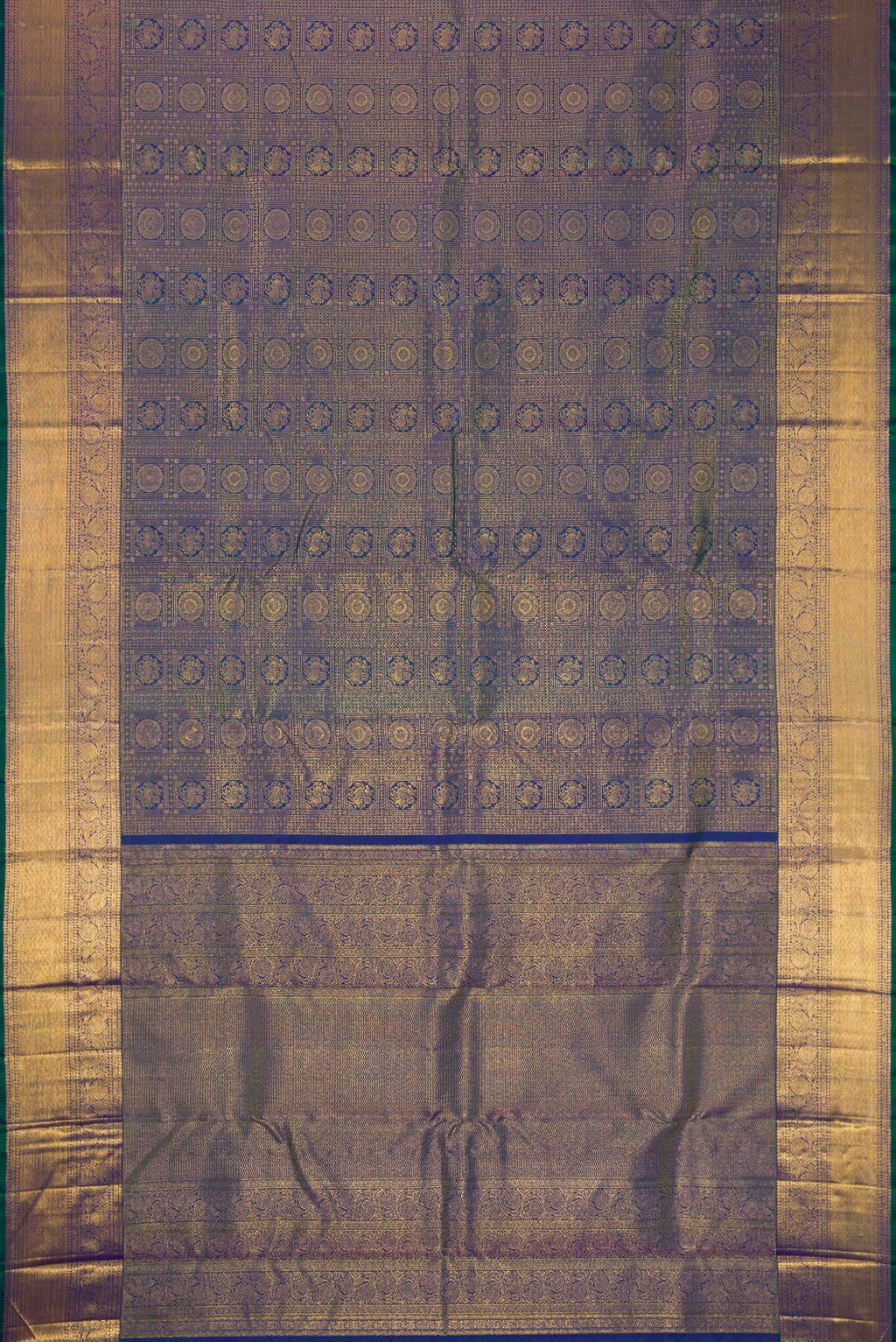 Flat view of Peacock Blue Dual Tone Kanchipuram Silk Saree with Zari Brocade on the body and Zari Border. 