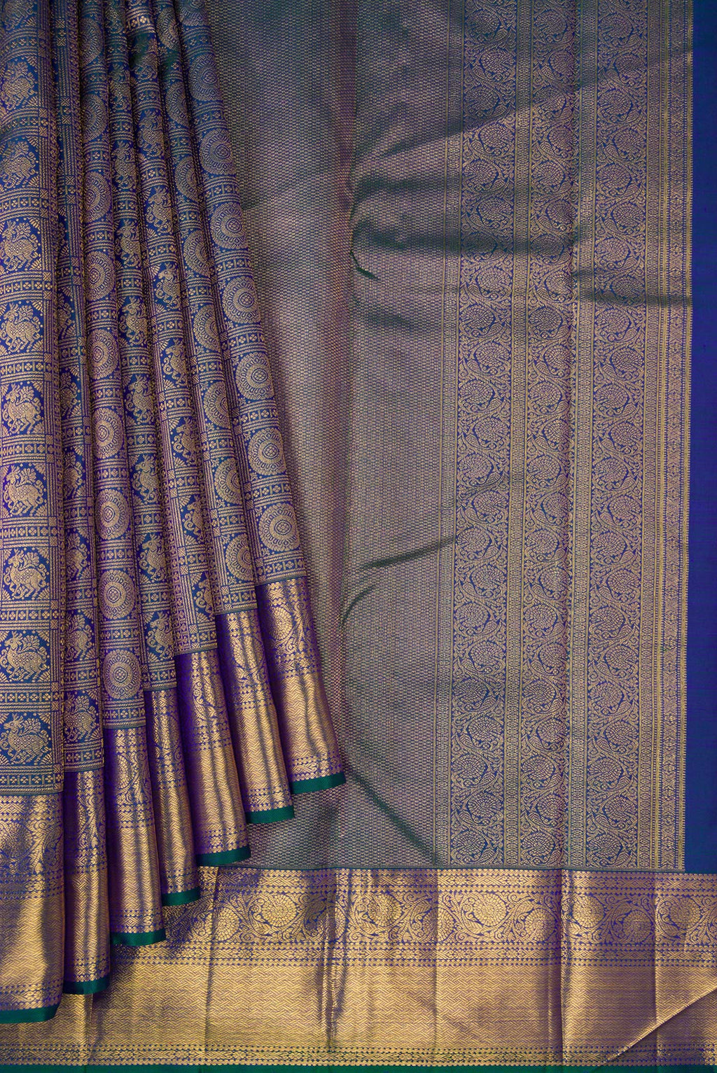Pleats and pallu of Peacock Blue Dual Tone Kanchipuram Silk Saree with Zari Brocade on the body and Zari Border. 