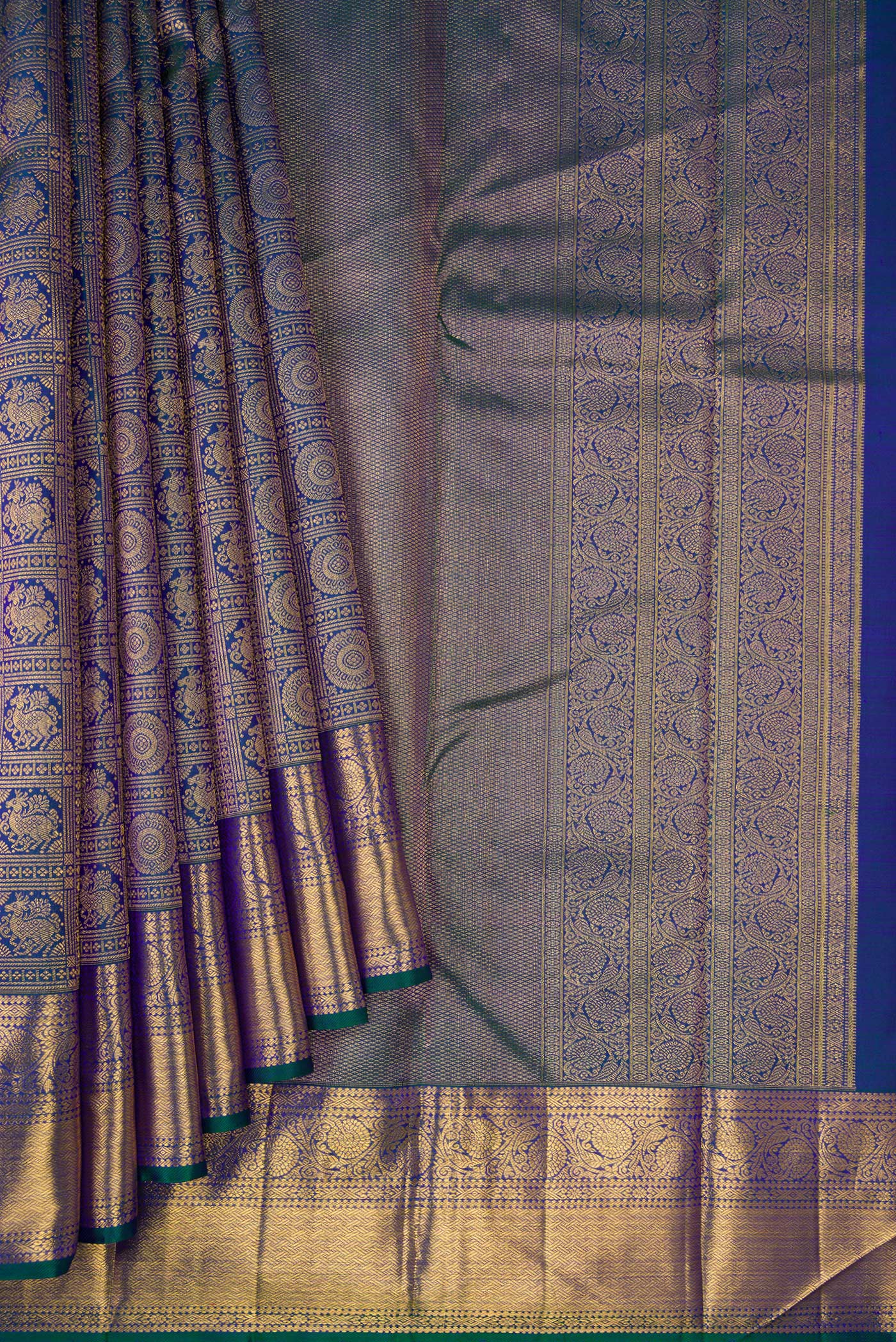 Pleats and pallu of Peacock Blue Dual Tone Kanchipuram Silk Saree with Zari Brocade on the body and Zari Border. 