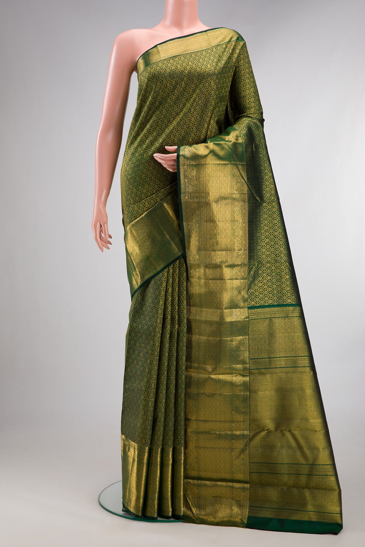 Pure Silk Bottle Green Kanchipuram Saree with Zari Brocade on the body and Zari Border.  displayed on a mannequin