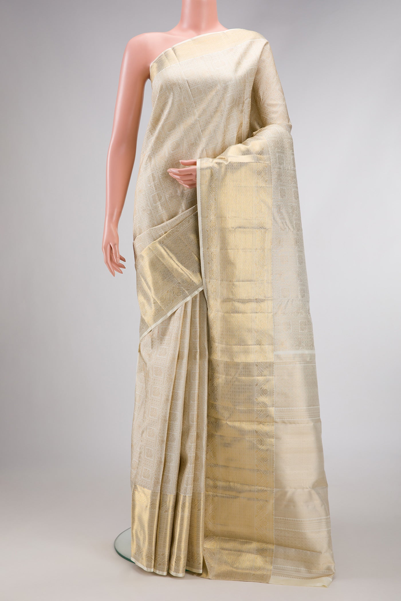 Off White Dual Tone Kanchipuram Silk Saree with Zari Brocade on the body and Zari Border.  displayed on a mannequin