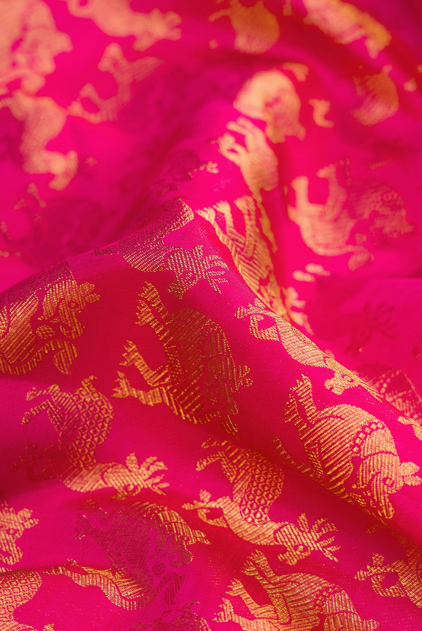 Close up of Pink Dual Tone Kanchipuram Silk Saree with Zari Brocade on the body and Zari Border.  displaying folds