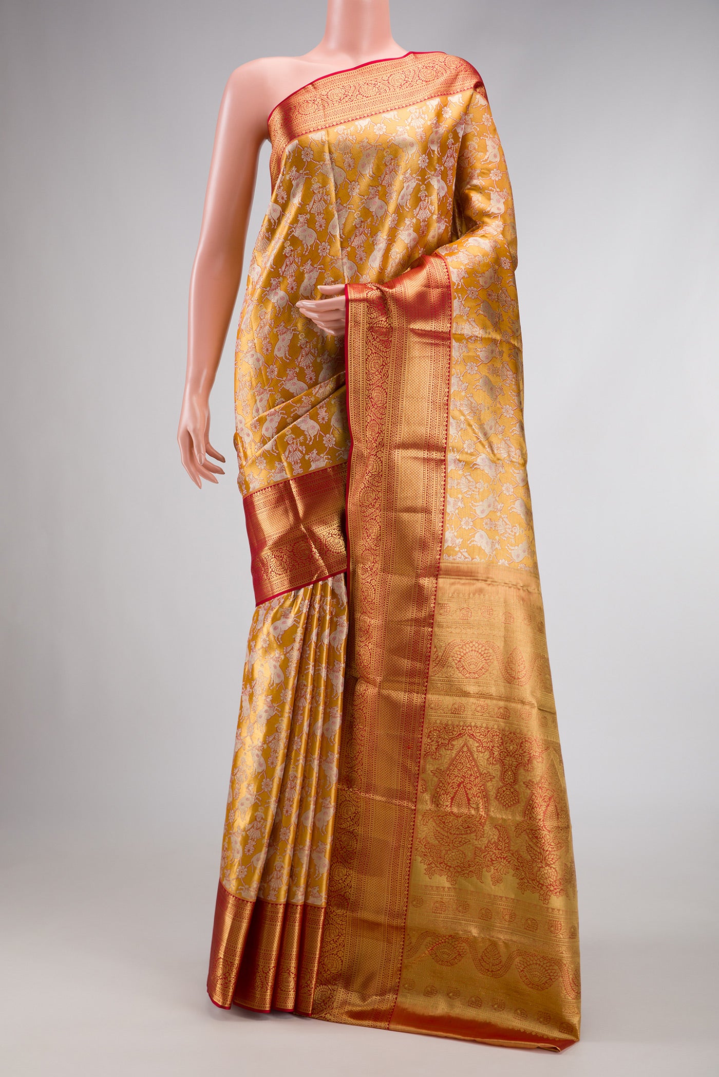 Gold Dual Tone Kanchipuram Tissue Silk Saree with Zari Brocade on the body and Zari Border.  displayed on a mannequin