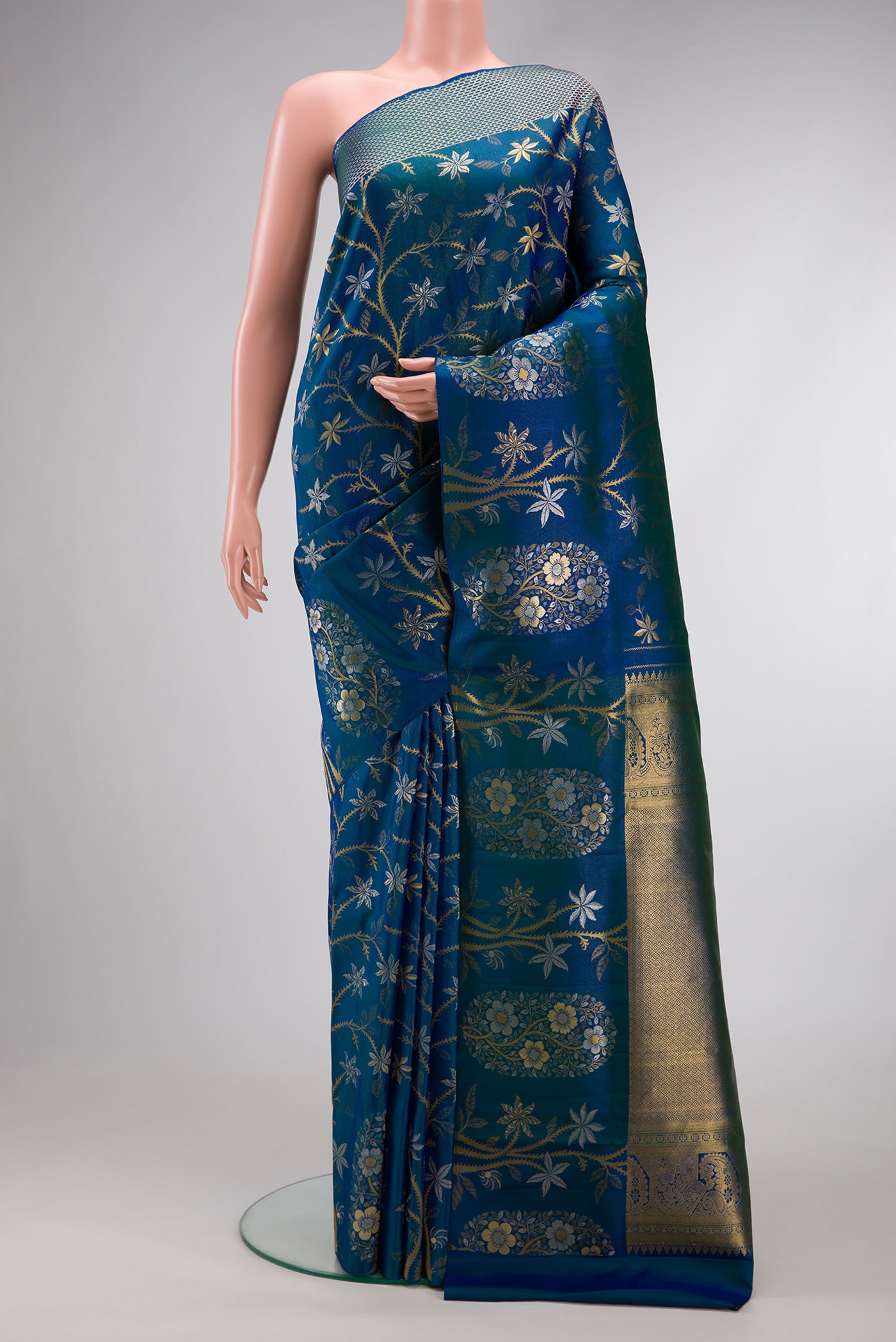Peacock Blue Dual Tone Kanchipuram Silk Saree with Zari Brocade on the body and Fancy Border.  displayed on a mannequin