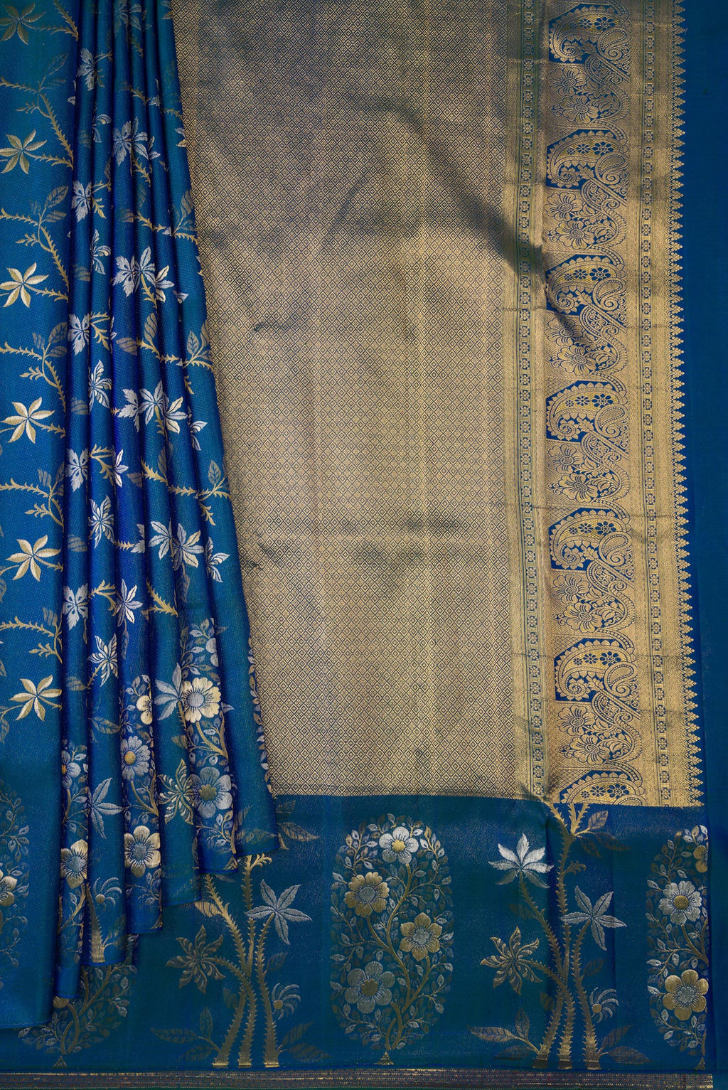 Pleats and pallu of Peacock Blue Dual Tone Kanchipuram Silk Saree with Zari Brocade on the body and Fancy Border. 