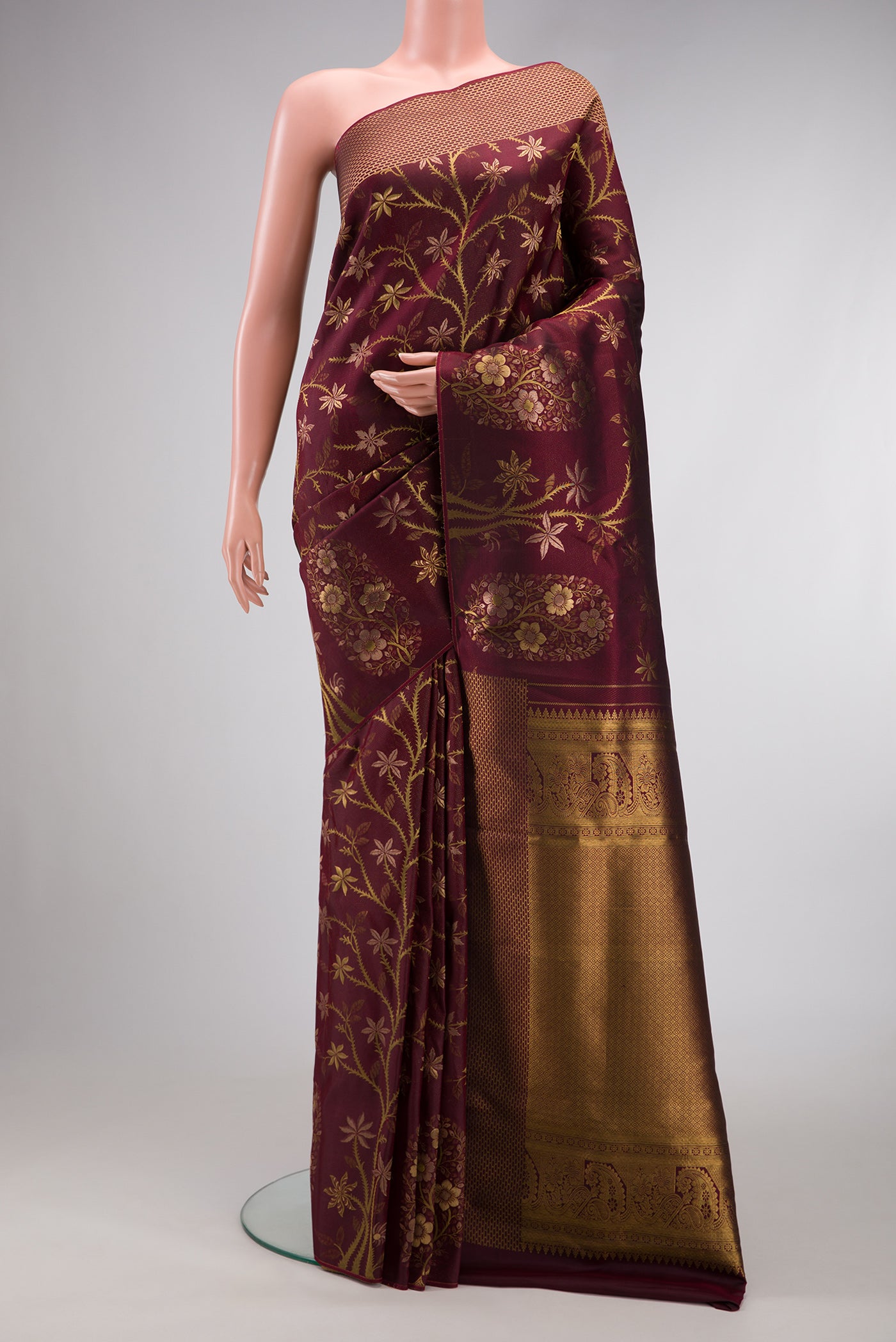 Maroon Dual Tone Kanchipuram Silk Saree with Zari Brocade on the body and Fancy Border.  displayed on a mannequin