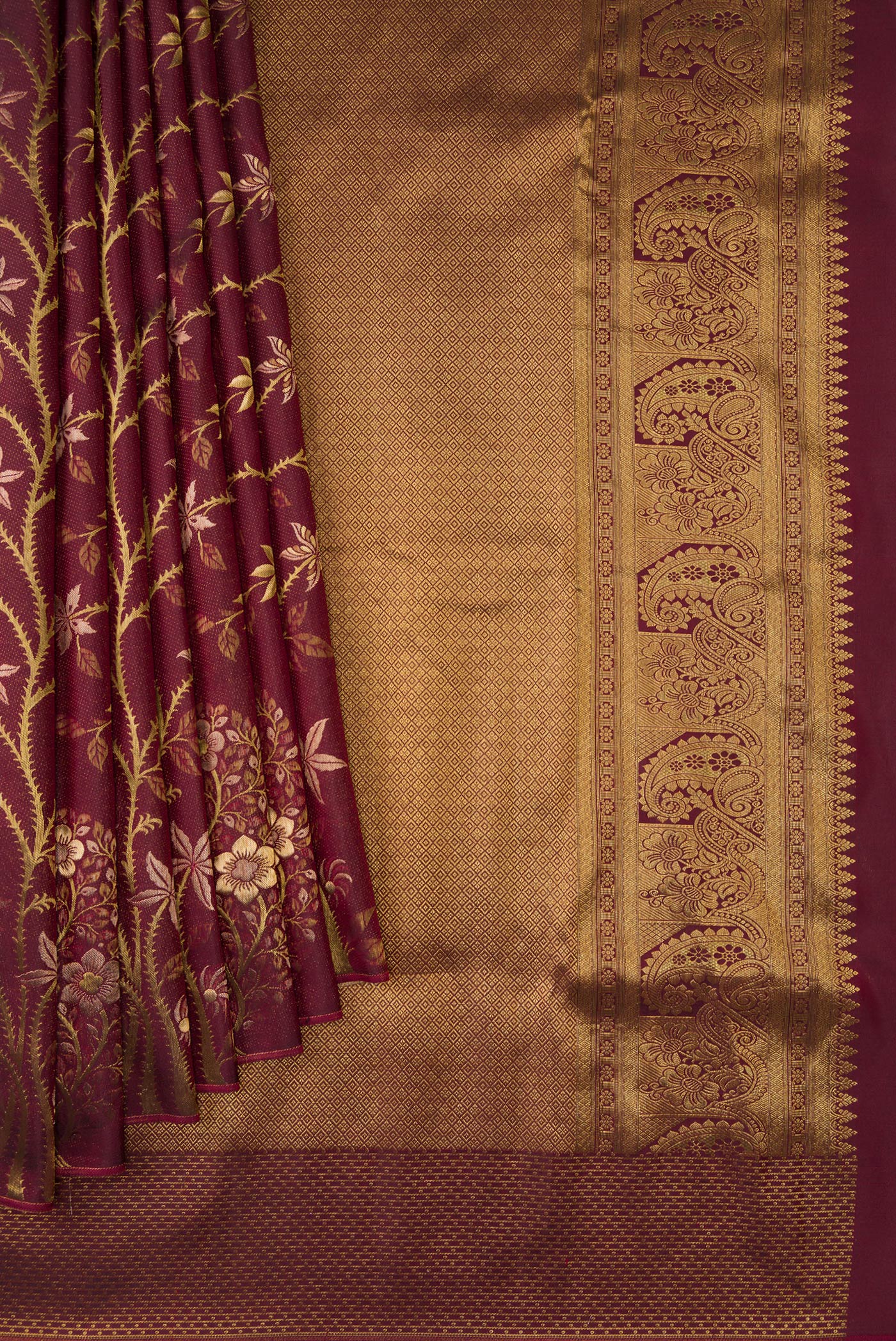 Pleats and pallu of Maroon Dual Tone Kanchipuram Silk Saree with Zari Brocade on the body and Fancy Border. 