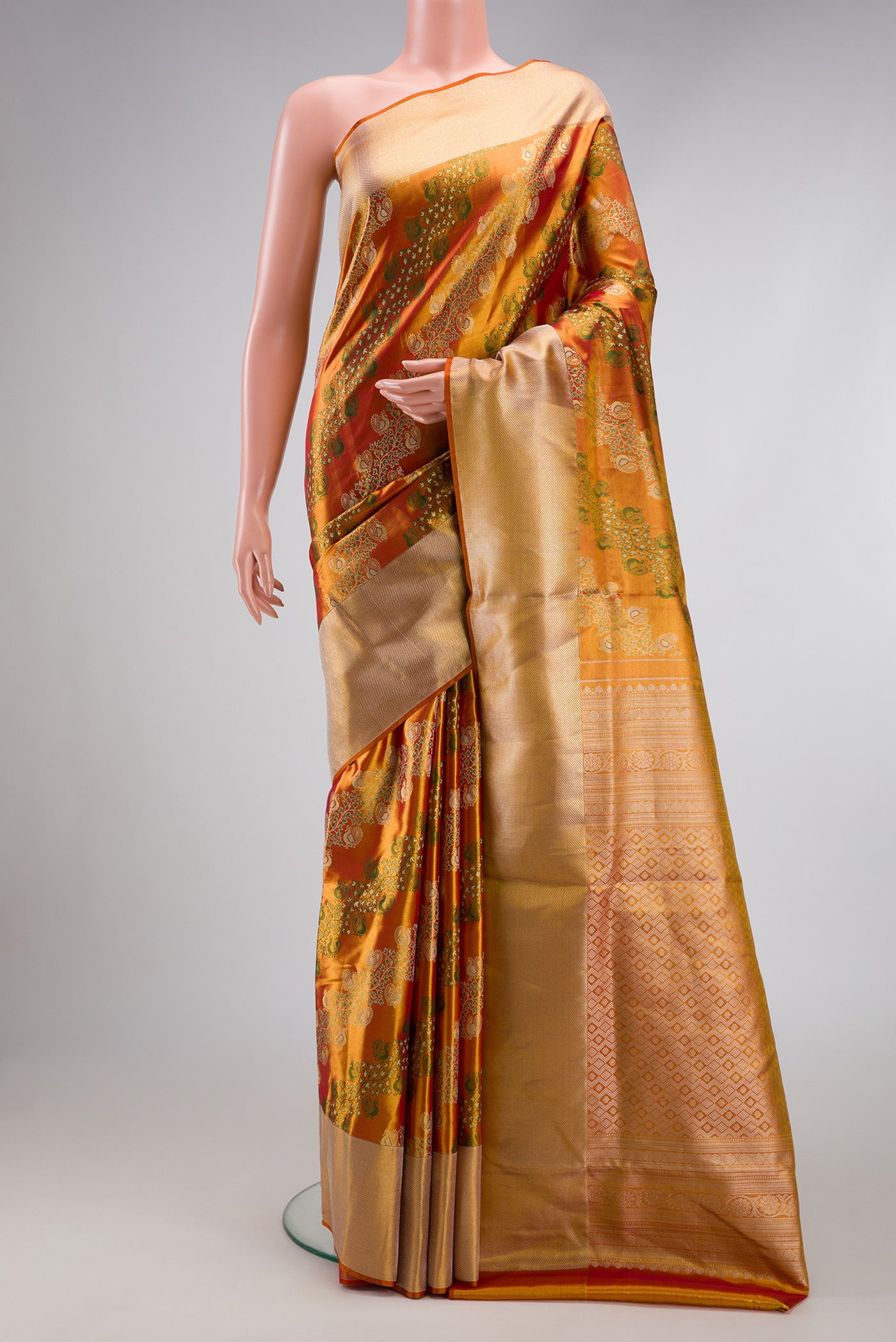 Golden Peach Dual Tone Kanjivaram Tissue Silk Saree with Zari Brocade on the body and Zari Border.  displayed on a mannequin