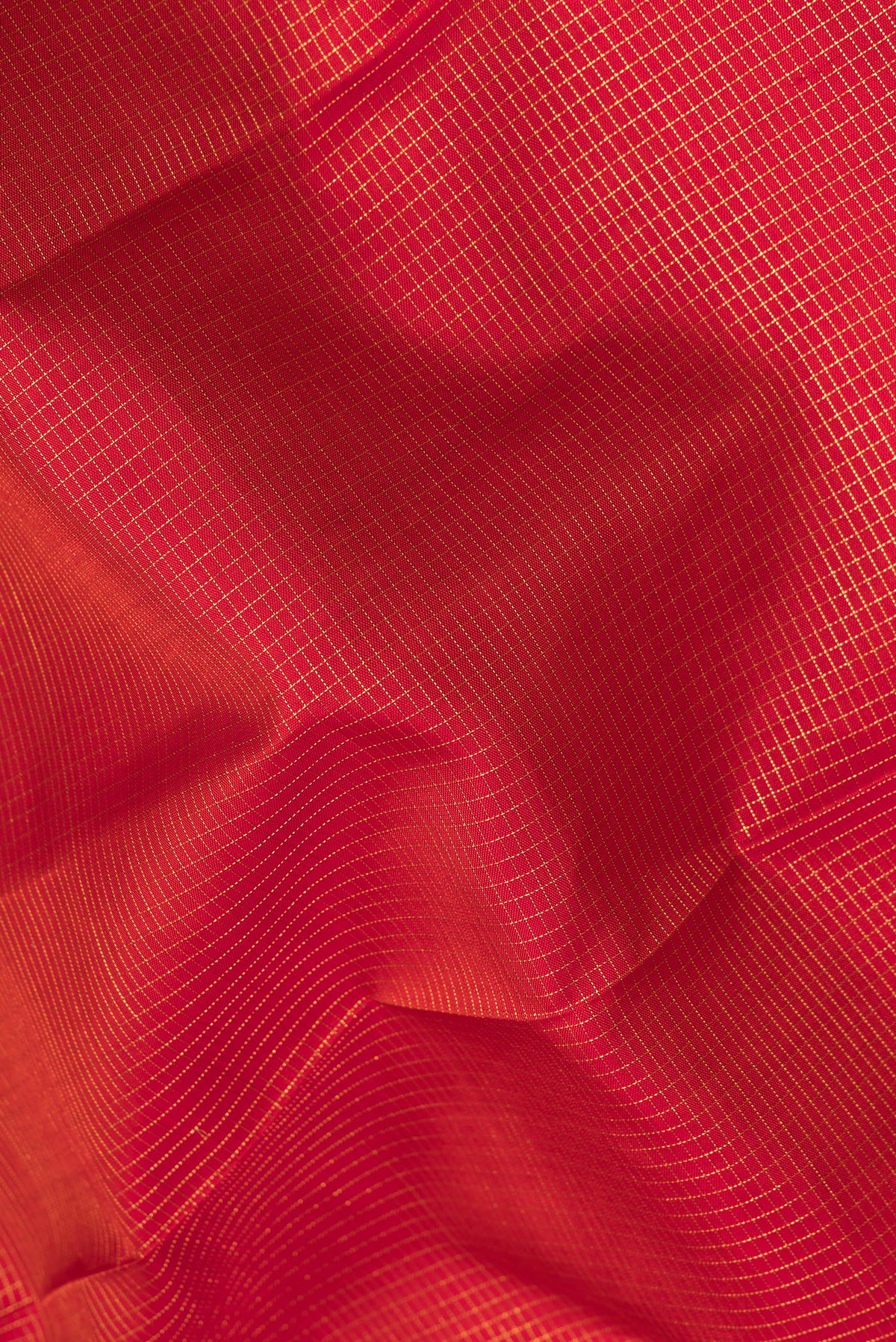 Close up of Pure Silk Maroon Dual Tone Kanjivaram Saree with Checked design on the body and Fancy Border.  displaying folds
