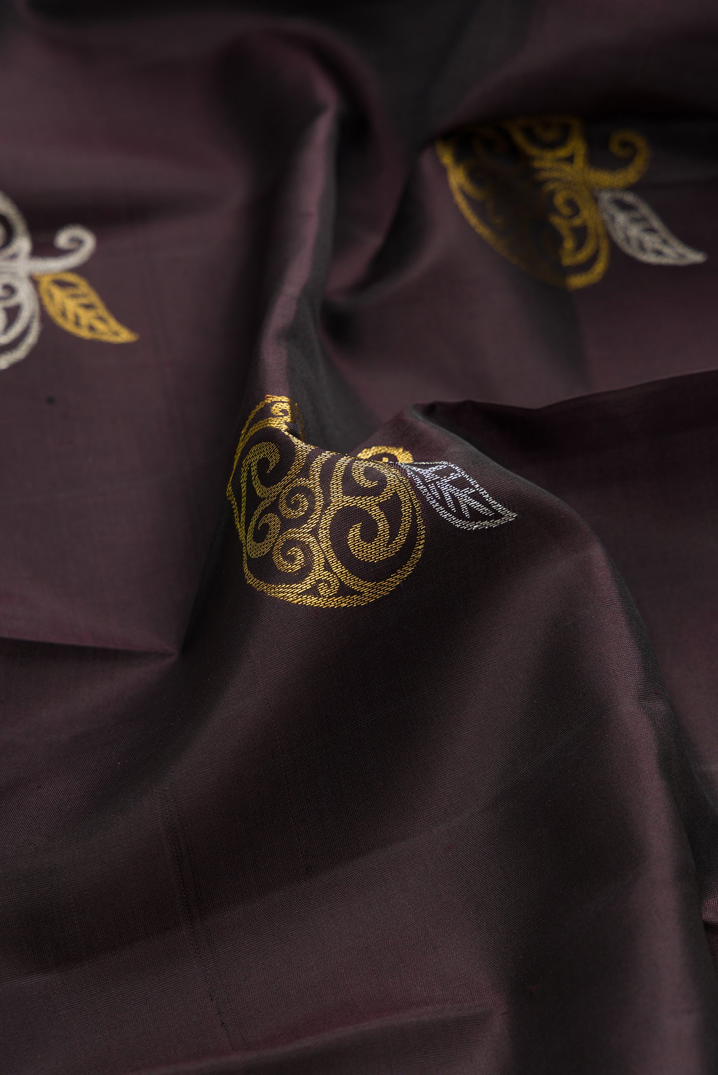 Close up of Coffee Brown Kanchipuram Silk Saree with Checked design on the body and Fancy Border.  displaying folds
