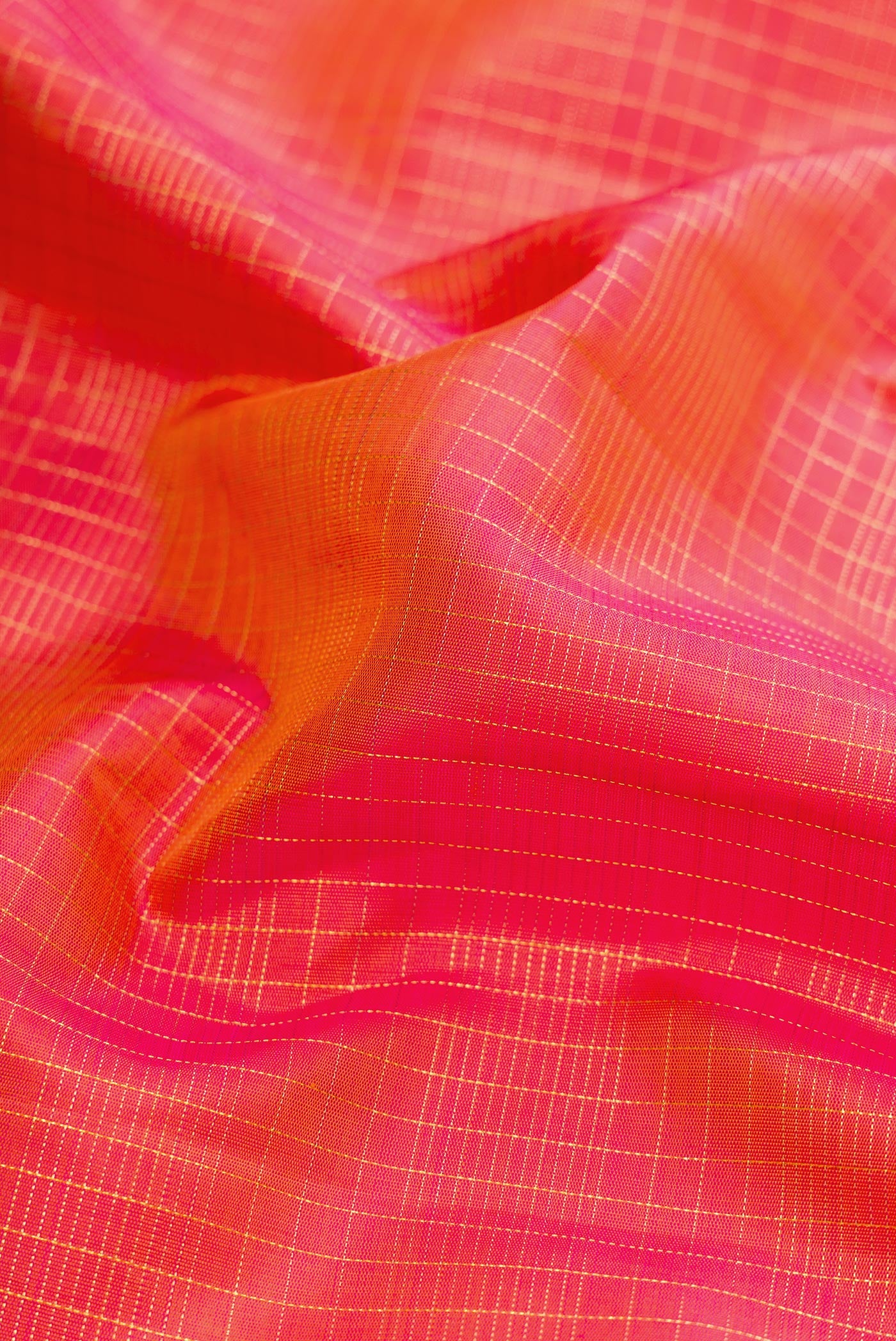 Close up of Pure Silk Pure Zari Coral Dual Tone Kanchipuram Nine Yards Saree with Checked design on the body and Zari Border.  displaying folds
