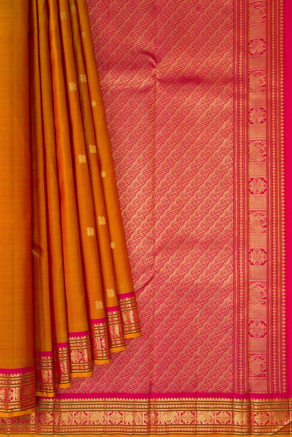 Pleats and pallu of Mustard Kanjivaram Silk Saree with Zari Butta on the body and Zari Border. 