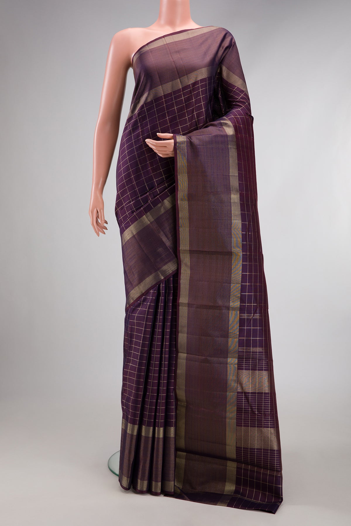 Purple Kanchipuram Silk Saree with Checked design on the body and Plain Border.  displayed on a mannequin
