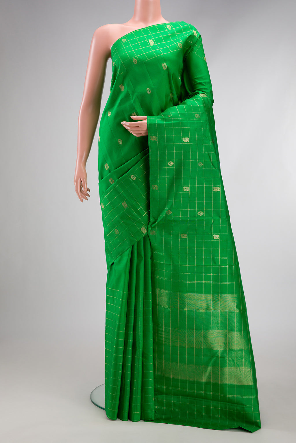 Green Kanchipuram Silk Saree with Zari Butta on the body and Checks Border.  displayed on a mannequin