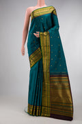 Peacock Blue Kanjivaram Silk Saree with Zari Butta on the body and Zari Border.  displayed on a mannequin