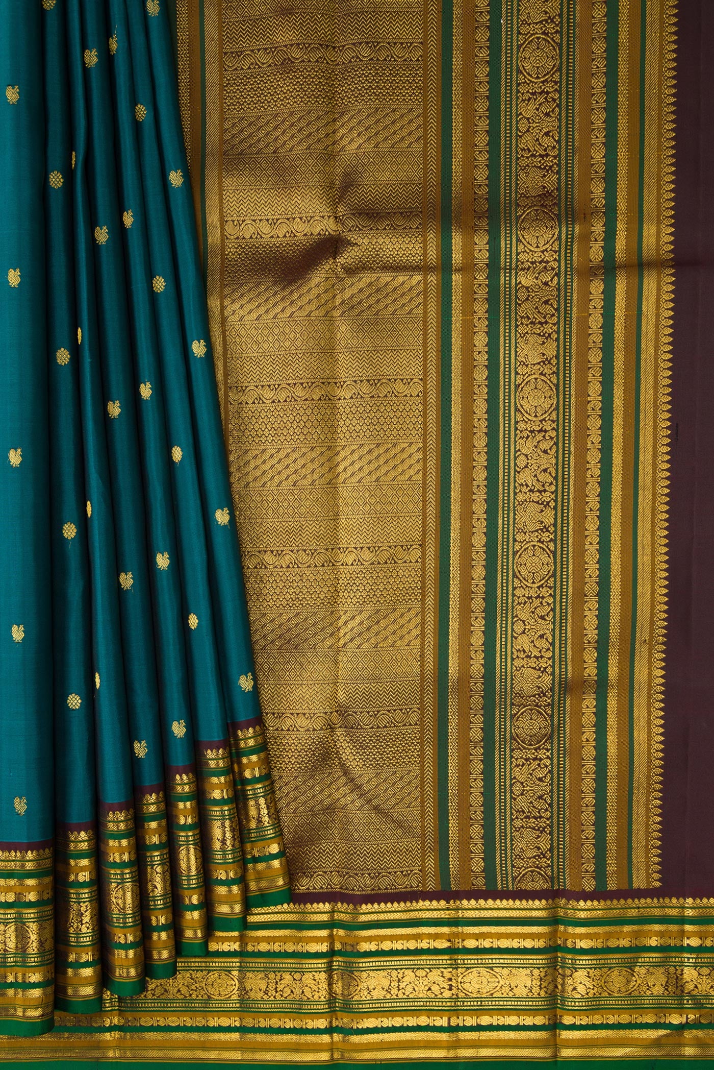 Pleats and pallu of Peacock Blue Kanjivaram Silk Saree with Zari Butta on the body and Zari Border. 