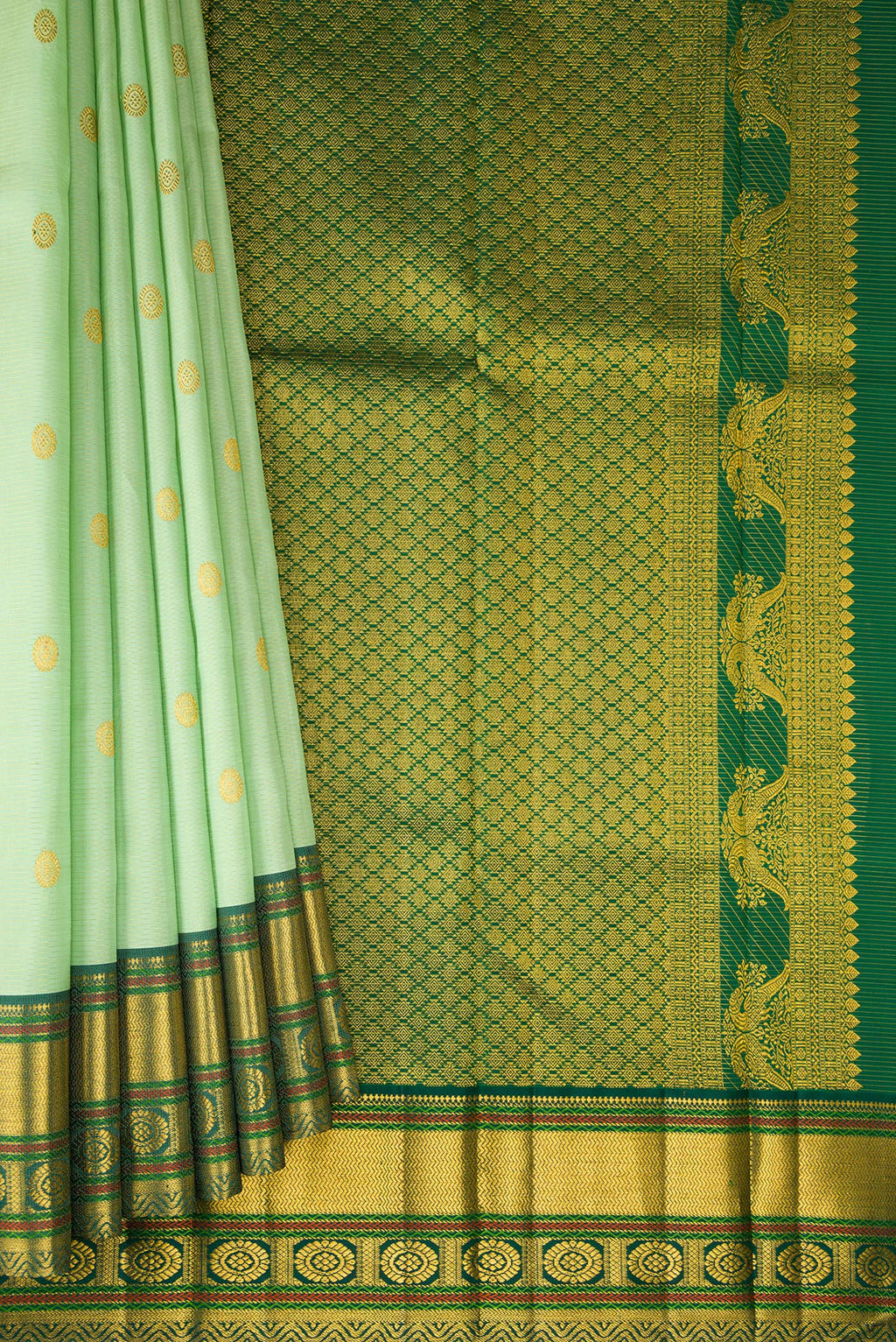 Pleats and pallu of Pista Green Kanchipuram Silk Saree with Zari Butta on the body and Zari Border. 