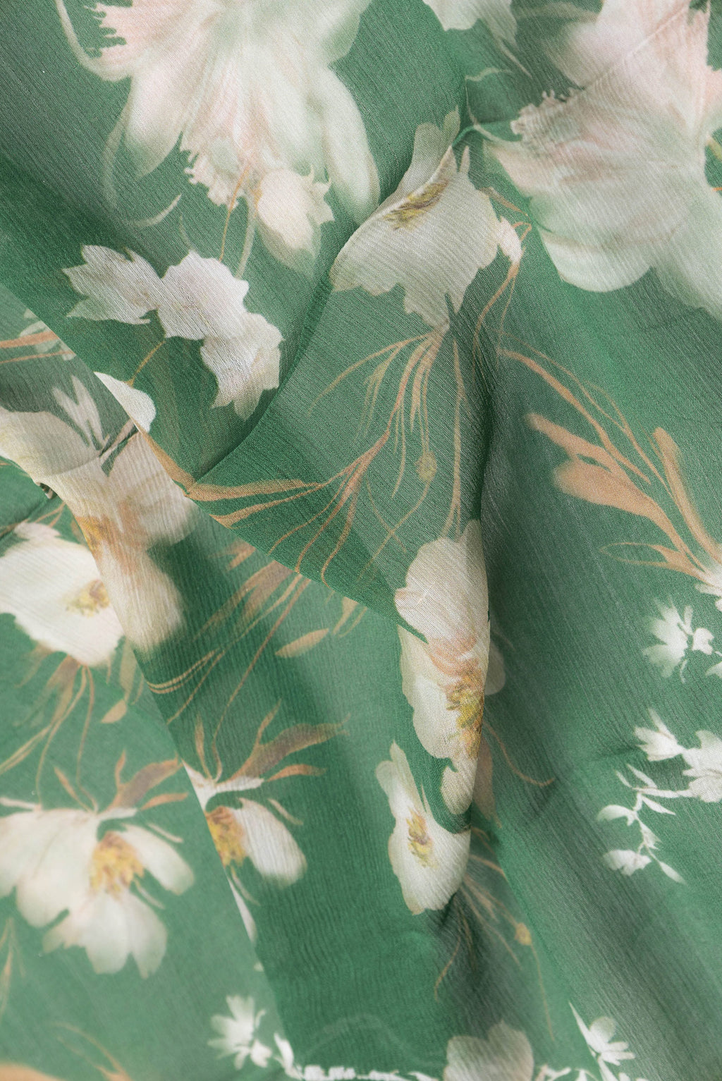 Close up of Green Dual Tone Mysore Chiffon Saree with Printed design on the body and Zari Border.  displaying folds