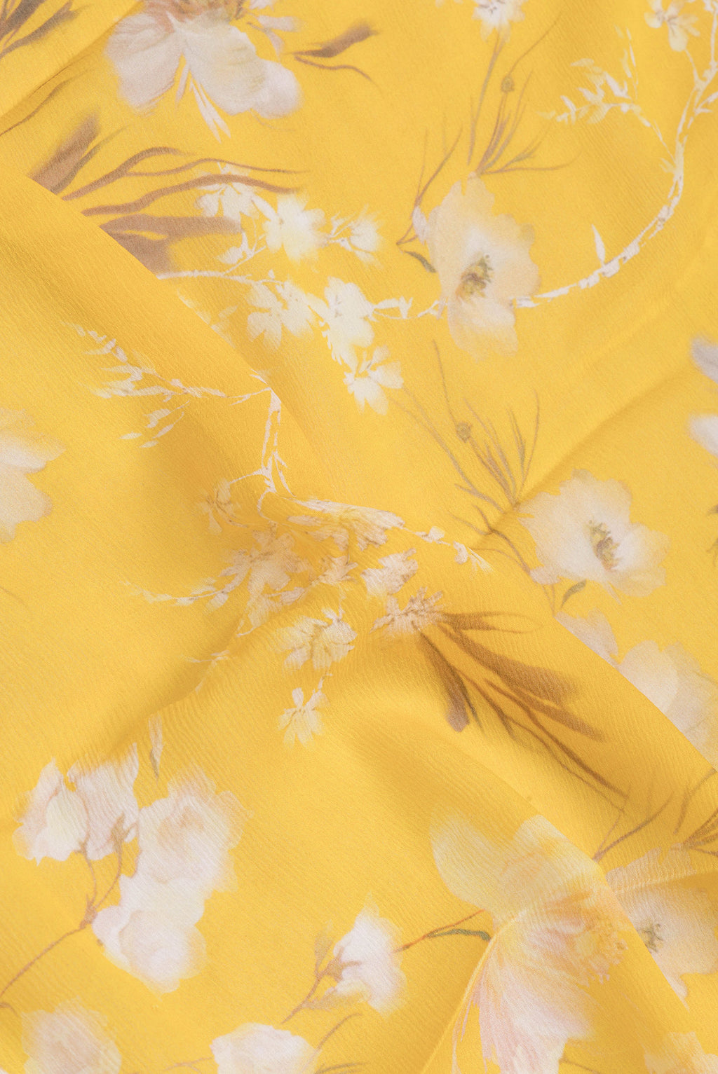 Close up of Yellow Mysore Chiffon Saree with Printed design on the body and Zari Border.  displaying folds
