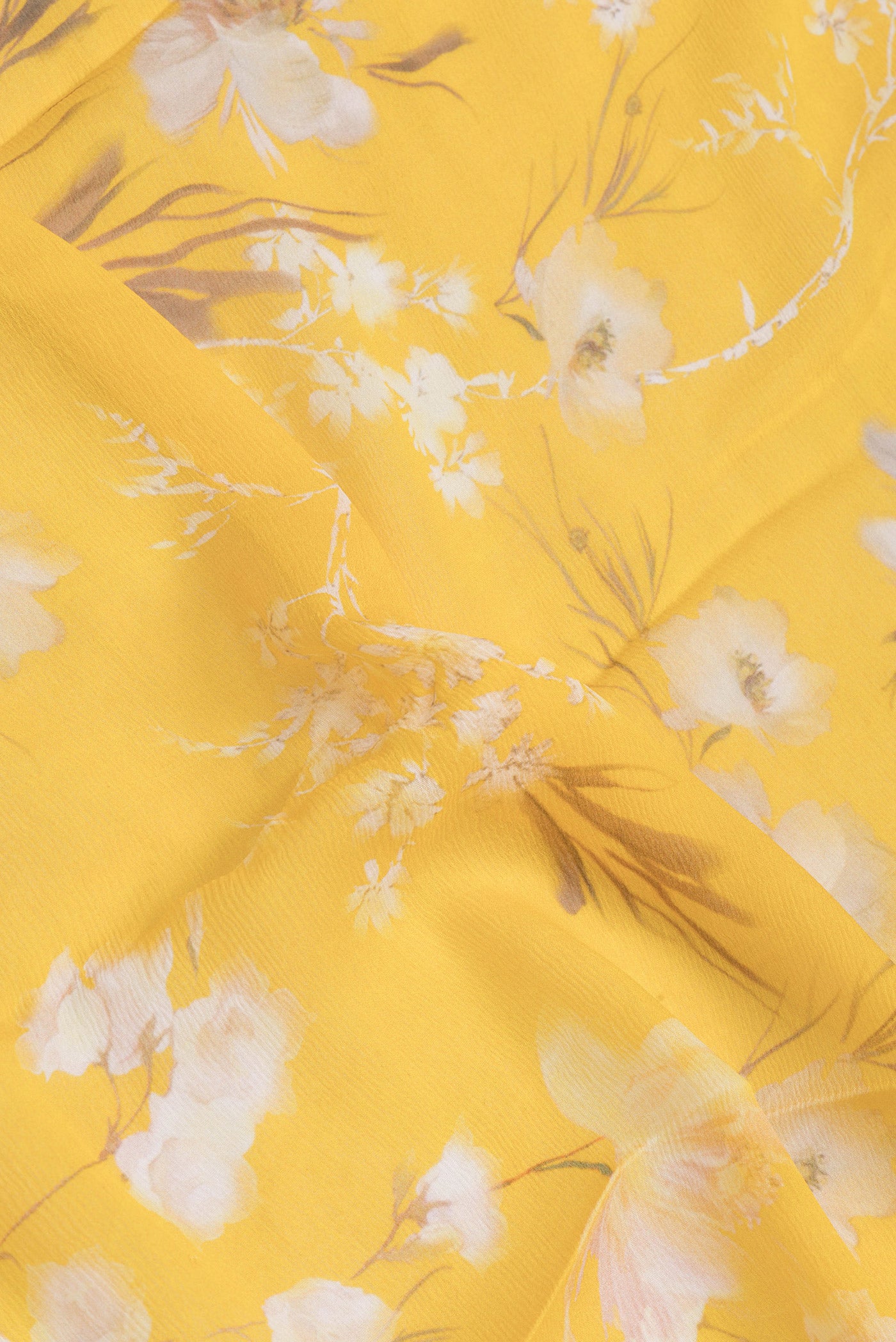 Close up of Yellow Mysore Chiffon Saree with Printed design on the body and Zari Border.  displaying folds