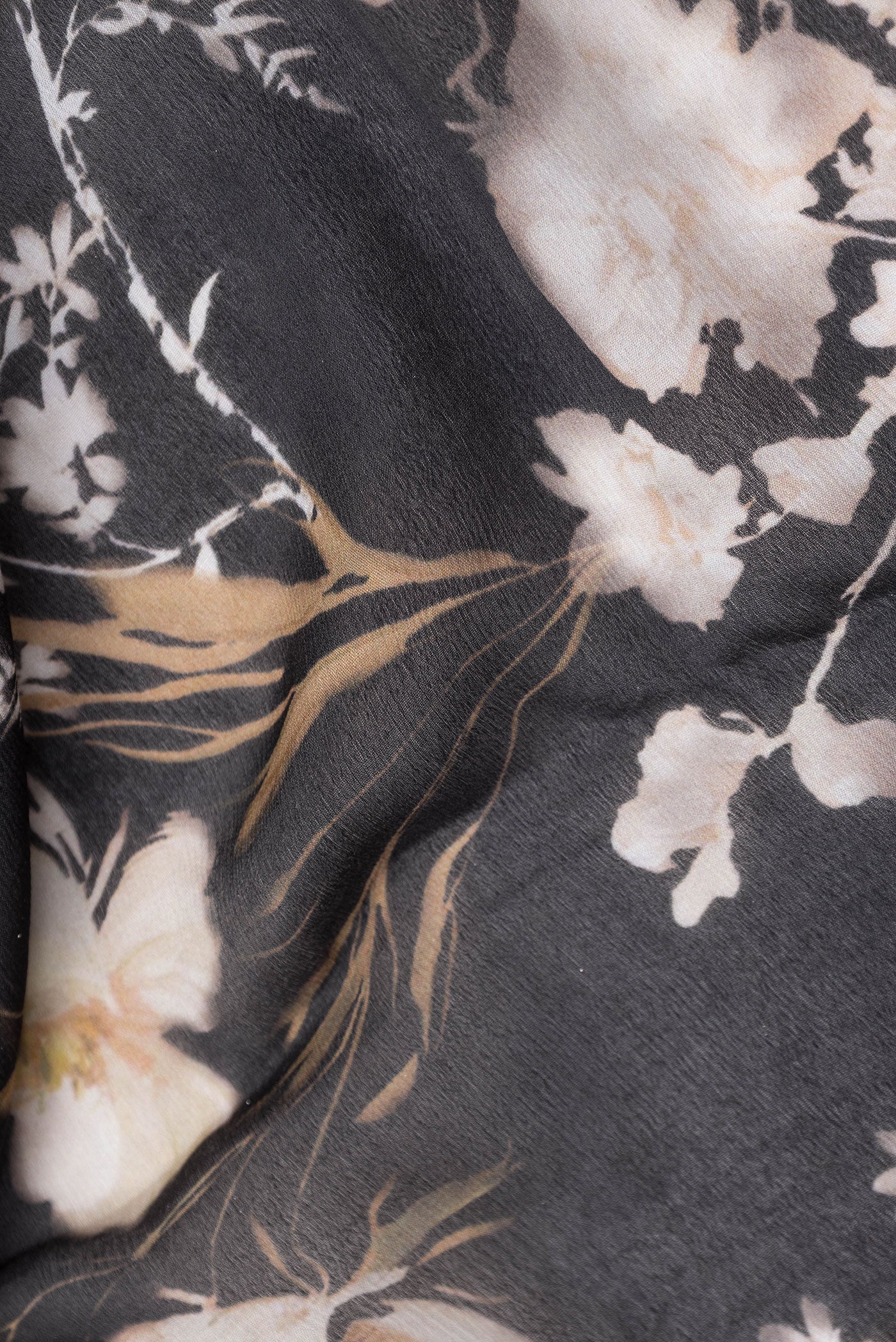 Close up of Black Mysore Chiffon Saree with Printed design on the body and Zari Border.  displaying folds