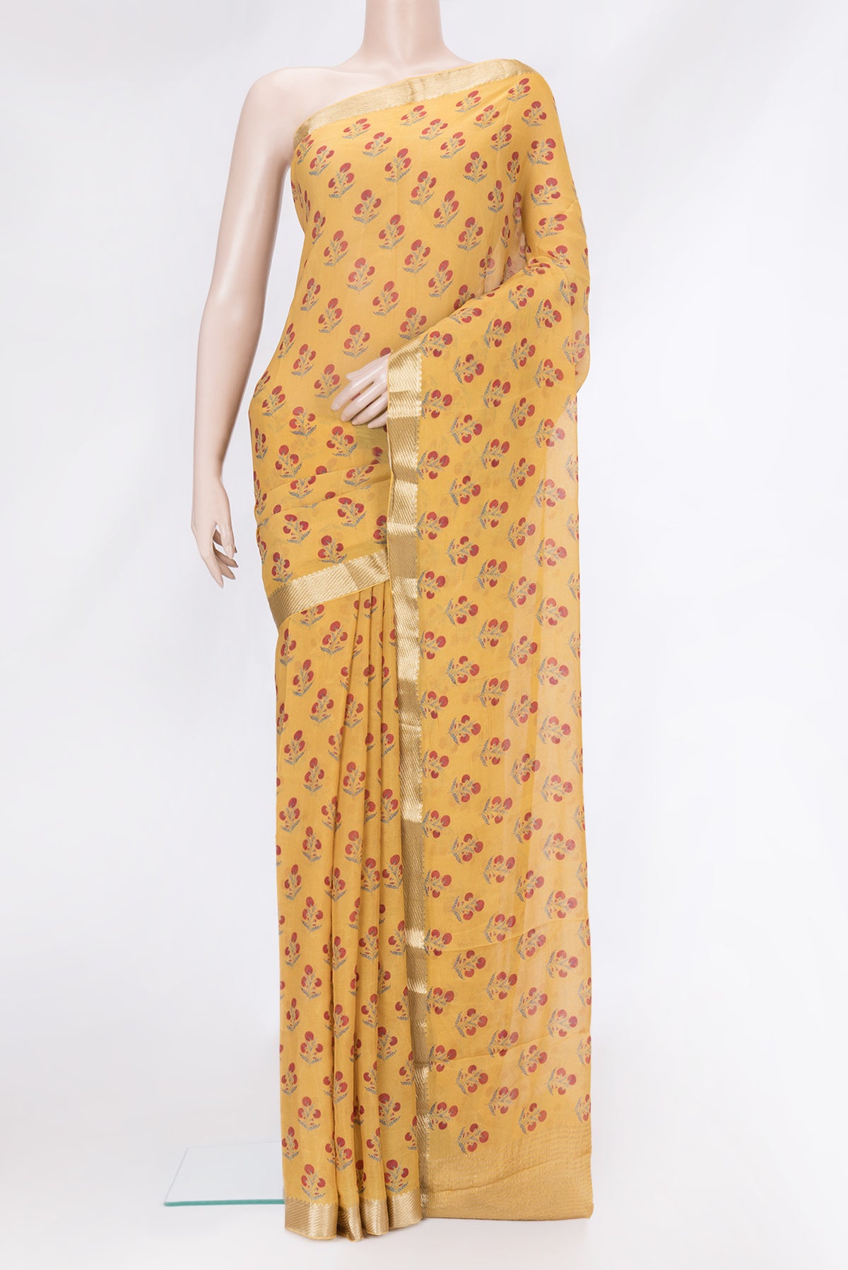 Mustard Mysore Chiffon Saree with Printed design on the body and Zari Border.  displayed on a mannequin