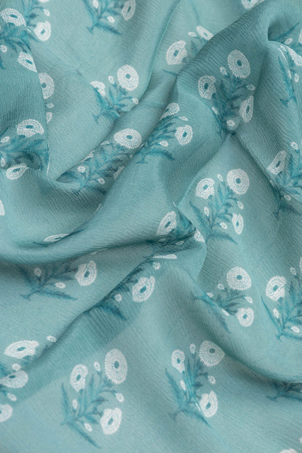 Close up of Maya Blue Dual Tone Mysore Chiffon Saree with Printed design on the body and Zari Border.  displaying folds