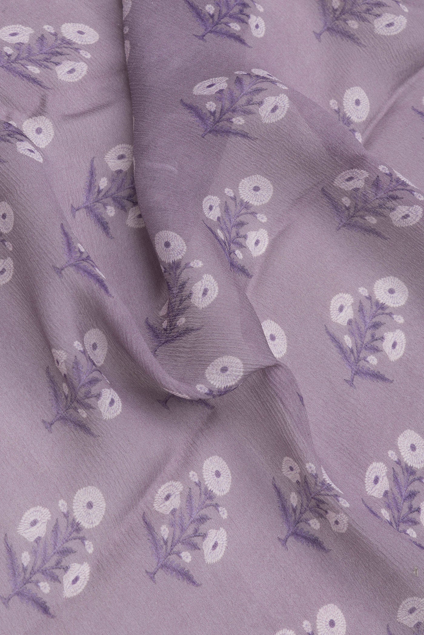 Close up of Lavender Mysore Chiffon Saree with Printed design on the body and Zari Border.  displaying folds