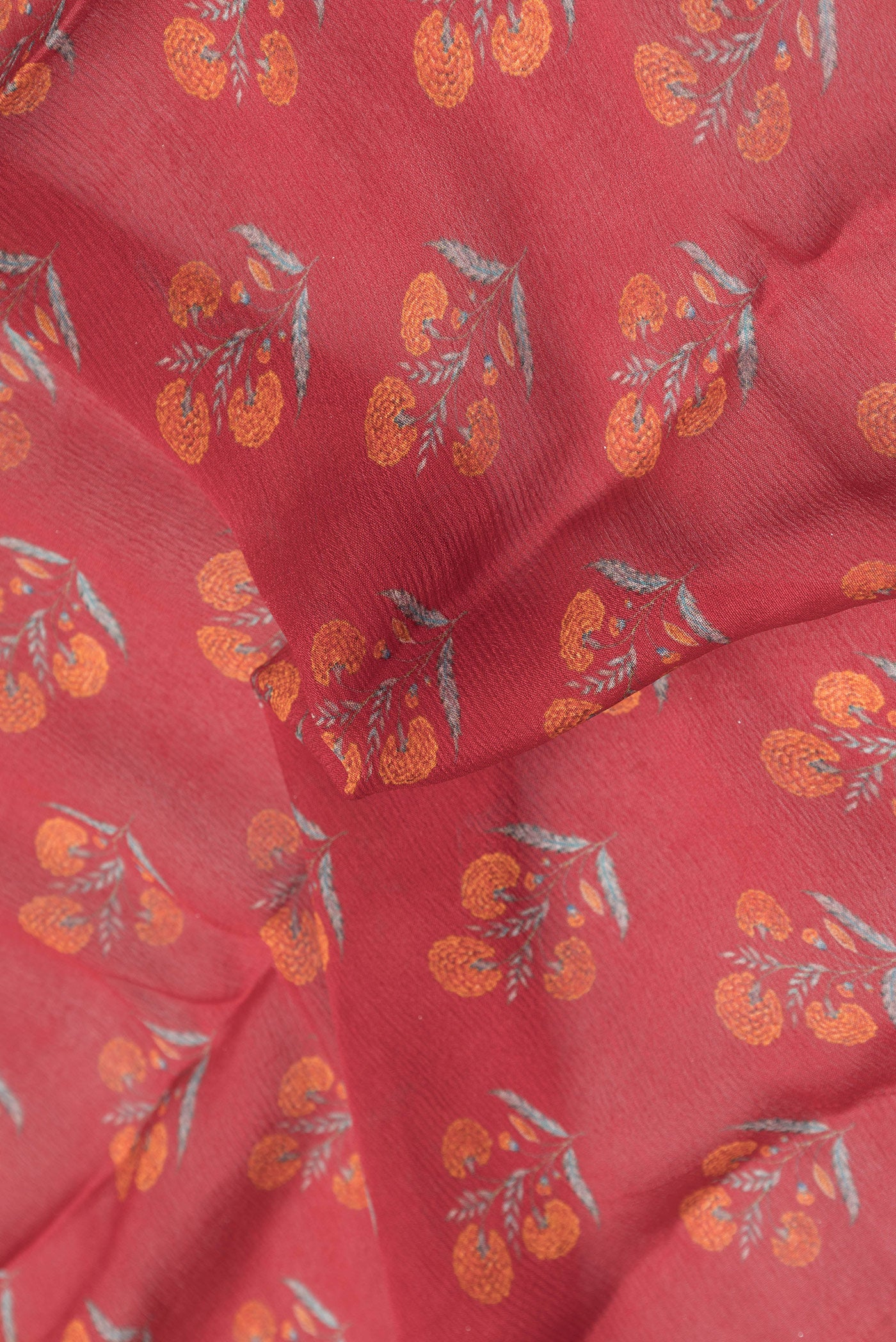 Close up of Red Dual Tone Mysore Chiffon Saree with Printed design on the body and Zari Border.  displaying folds