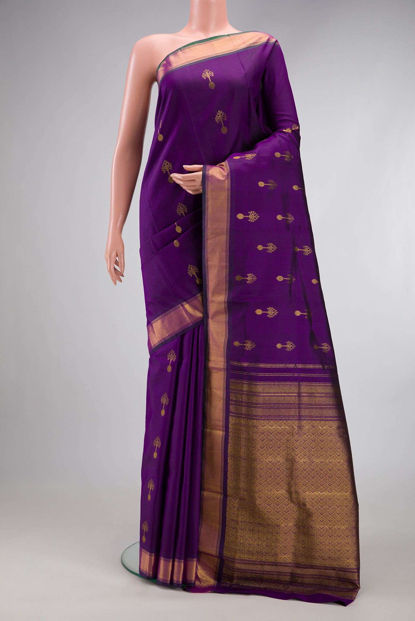 Purple Kanjivaram Silk Saree with Zari Butta on the body and Zari Border.  displayed on a mannequin